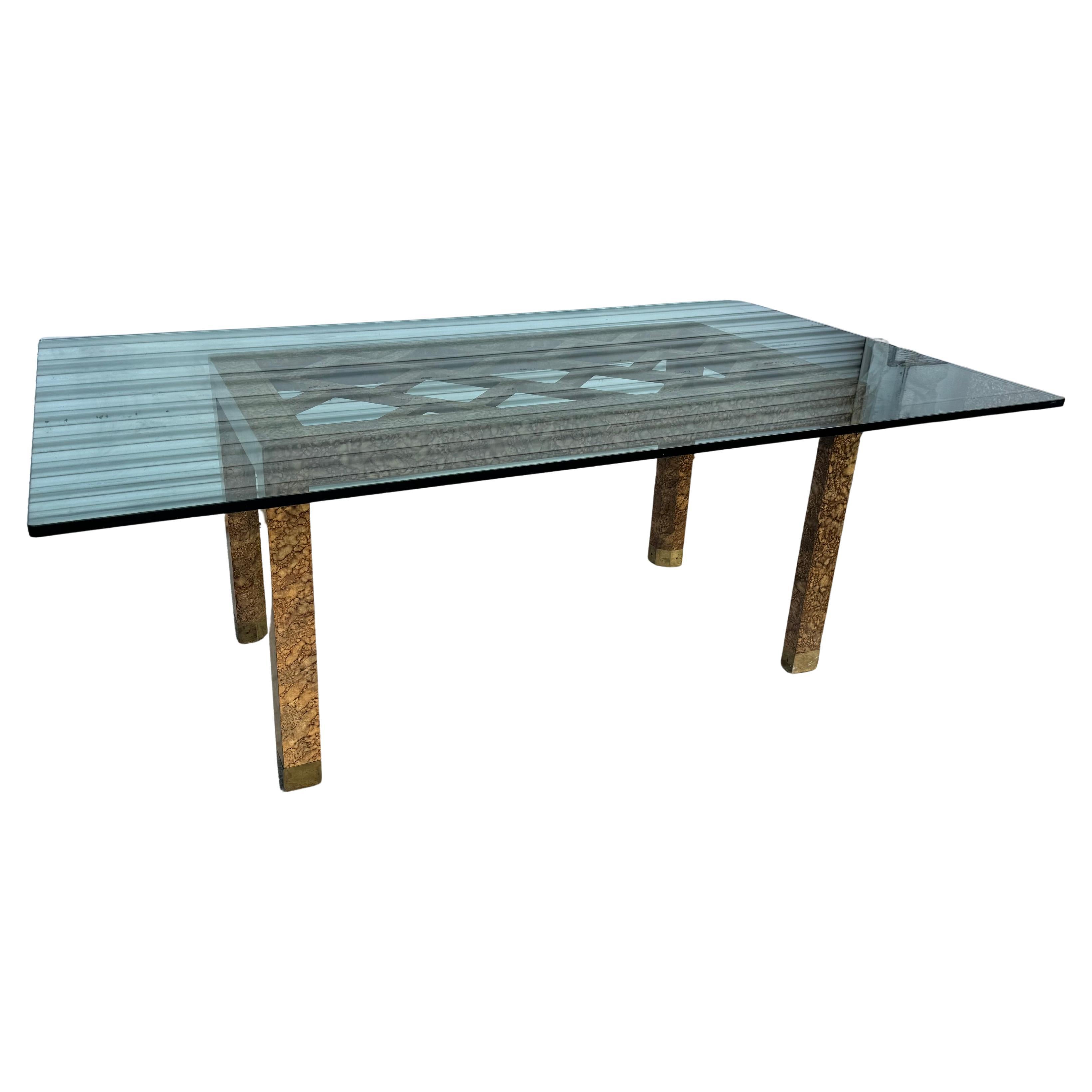 This luxurious dining table base has a tortoise shell style veneer. The feet have brass caps and the top is 3/4