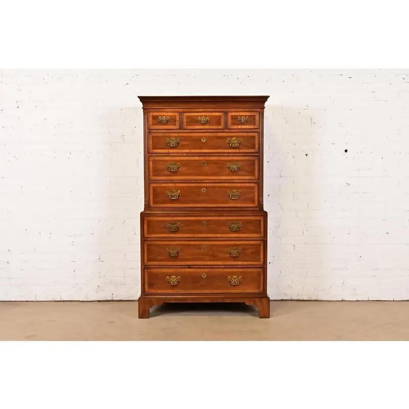 An exceptional Georgian or Chippendale style nine-drawer highboy dresser

By Henredon

USA, Circa 1980s

Gorgeous mahogany, with satinwood banding, and original brass hardware.

Measures: 38