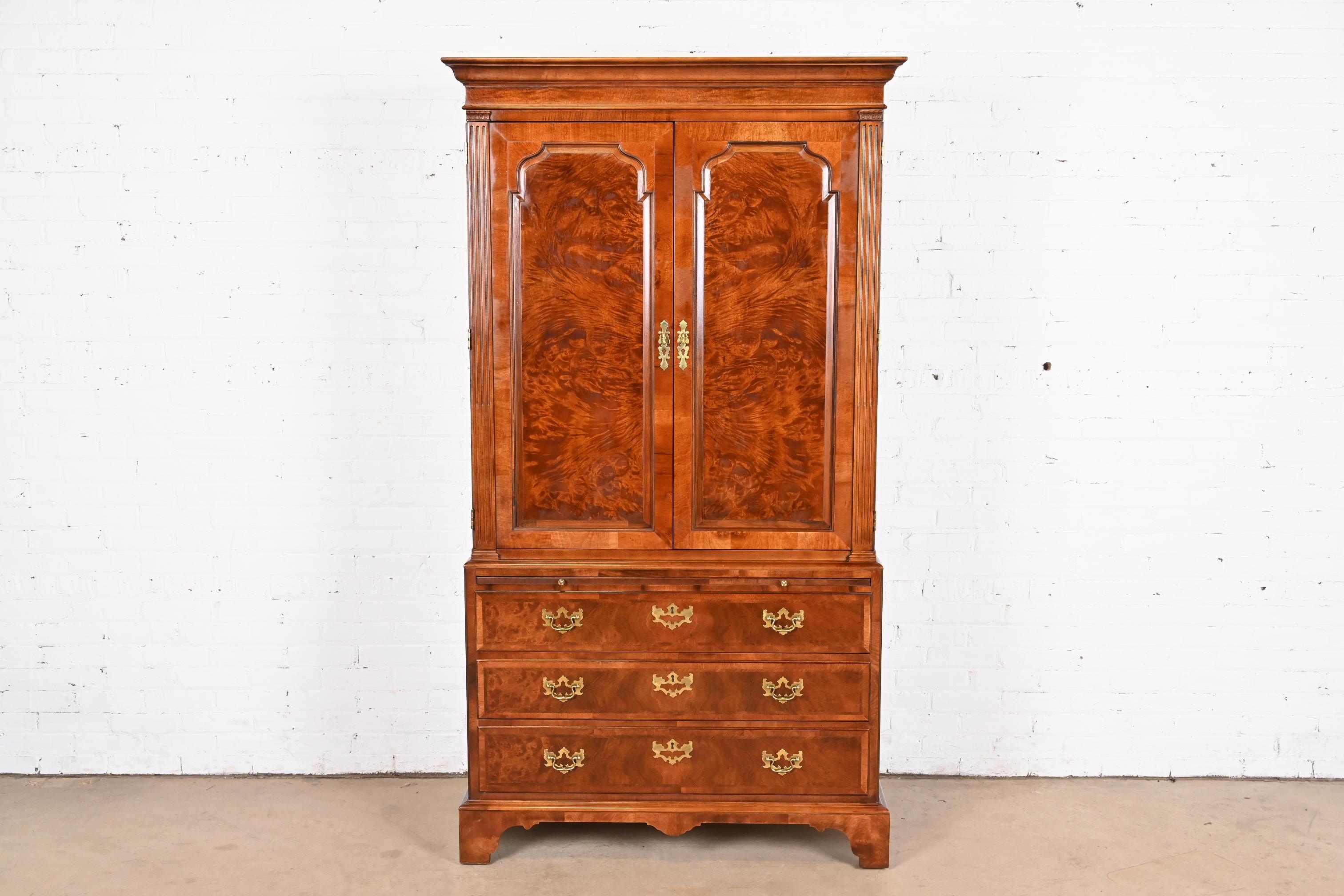 A gorgeous Georgian or Chippendale style wardrobe, armoire dresser, or linen press

By Henredon

USA, 1980s

Carved burled mahogany, with original brass hardware.

Measures: 44