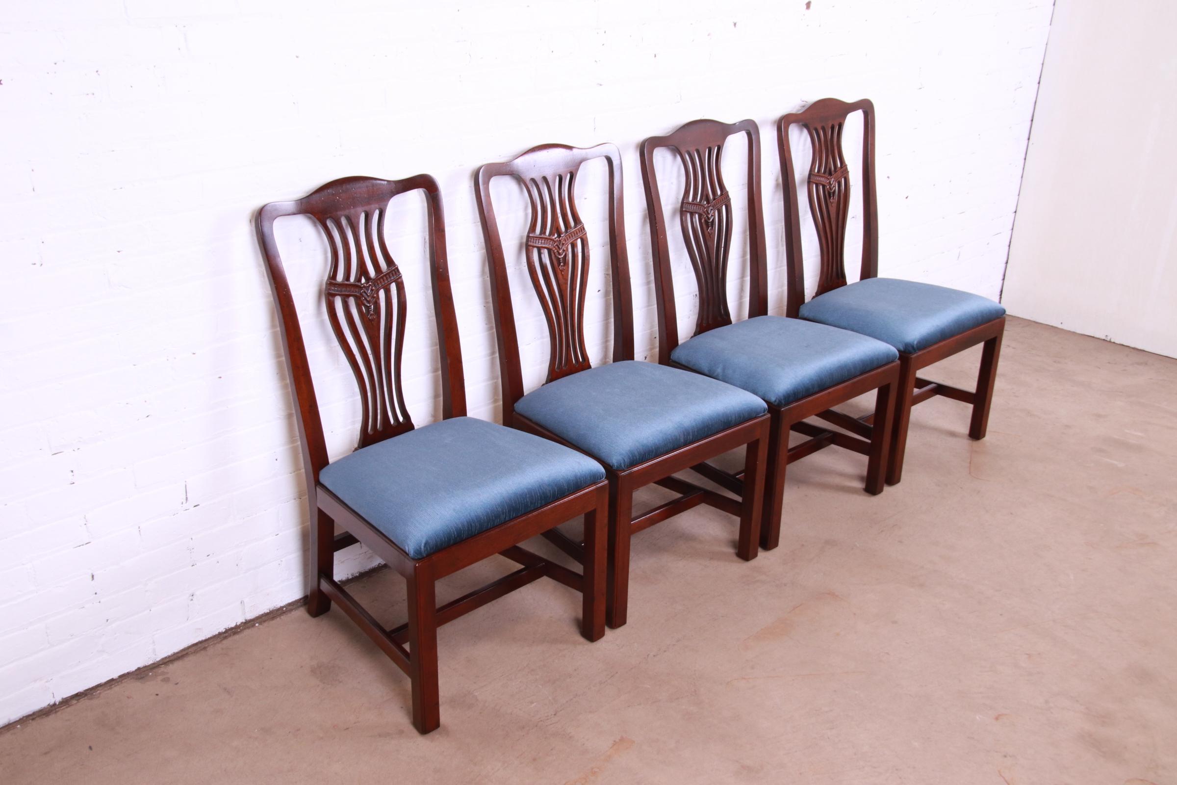 A gorgeous set of four Georgian or Chippendale style dining chairs

By Henredon

USA, Circa 1980s

Carved mahogany frames, with blue upholstered seats.

Measures: 20