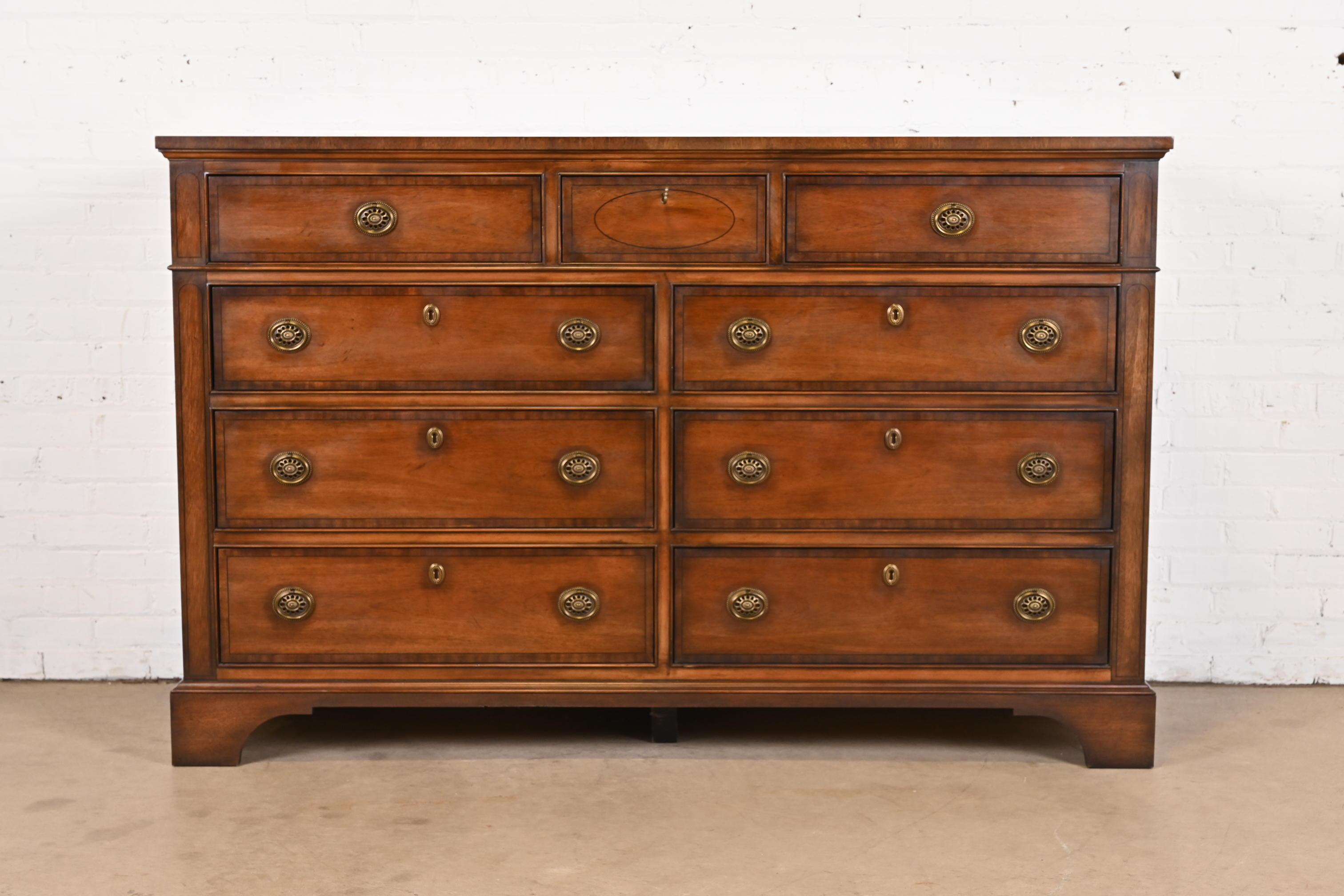 A gorgeous Georgian style nine-drawer dresser or chest of drawers

By Henredon

USA, Circa Late 20th Century

Beautiful banded mahogany, with original brass hardware.

Measures: 66.25