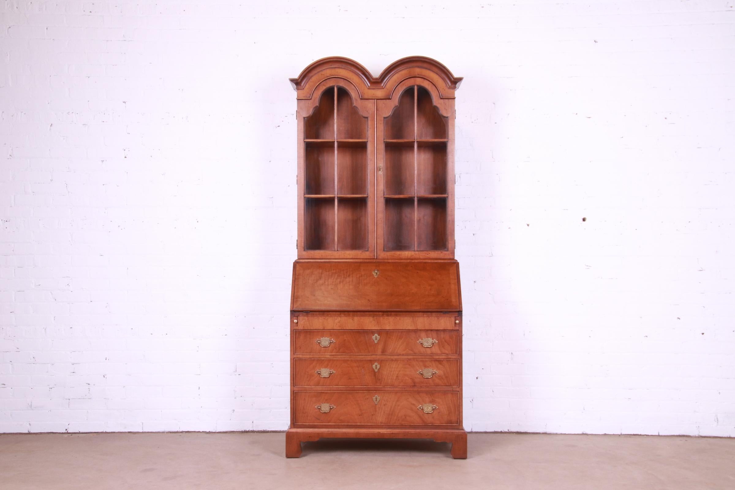 A beautiful Georgian or Queen Anne style bureau with drop front secretary desk and bookcase hutch top

By Henredon

USA, Circa 1980s

Gorgeous figured walnut, with original brass hardware and mullioned glass front doors.

Measures: 36