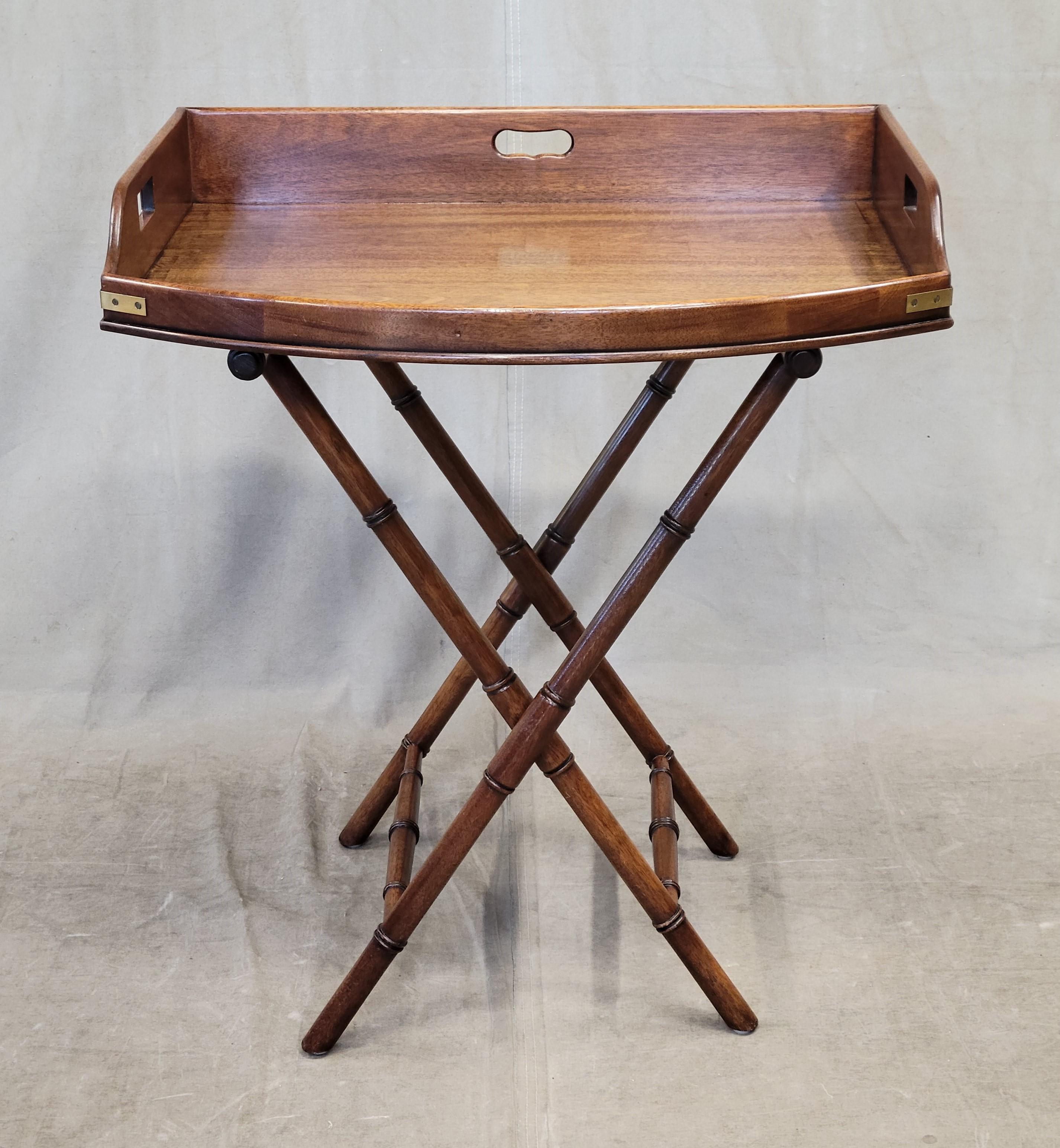 Perfect for the holidays is this stunning Henredon mahogany campaign style butler's tray table. The tray is removable and sits on a faux bamboo folding base, not only beautiful but so practical. Brass campaign style hardware contrasts with the