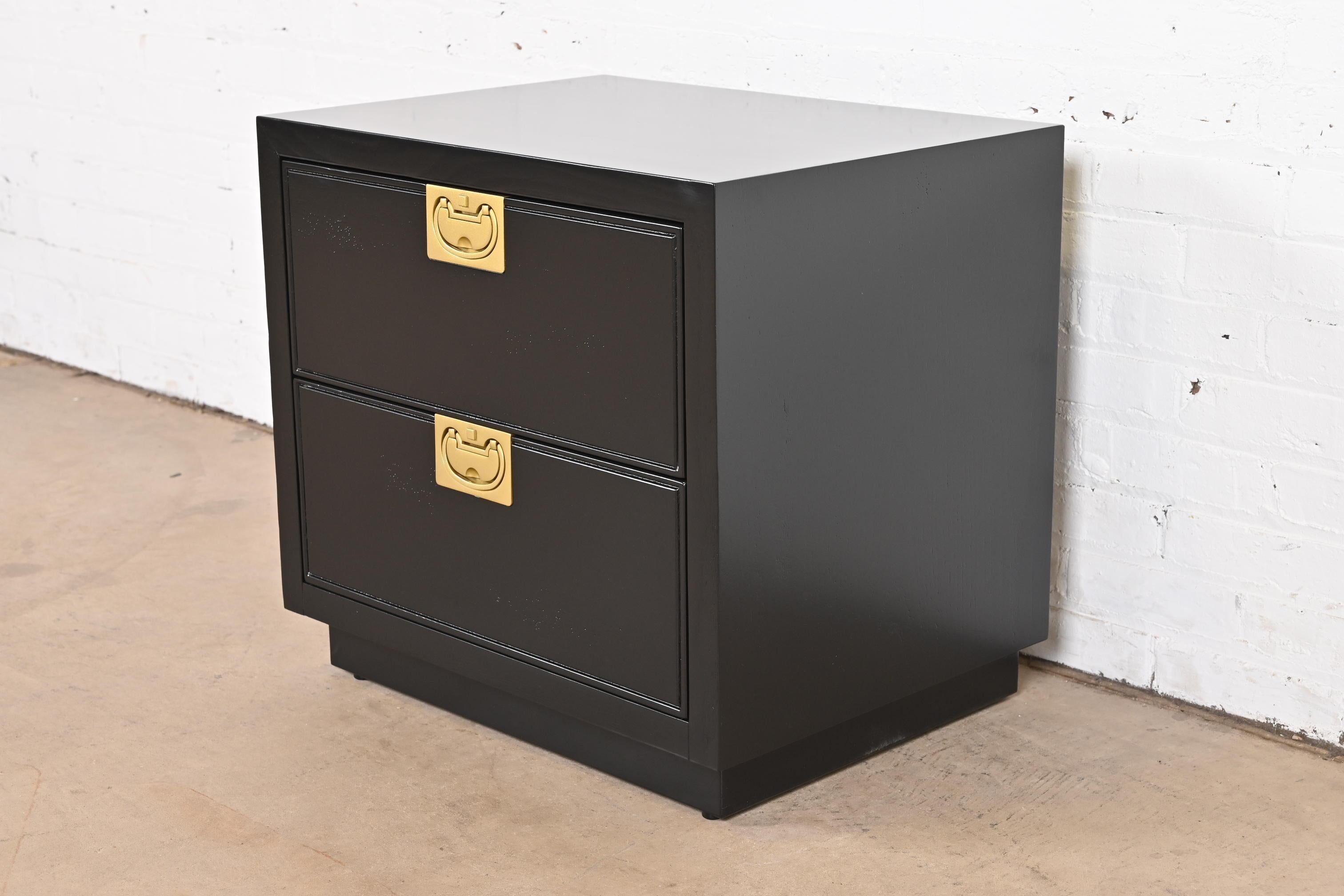 A gorgeous Mid-Century Modern Hollywood Regency Campaign style two-drawer nightstand or bedside chest

By Henredon

USA, circa 1970s

Black lacquered walnut, with original brass hardware.

Measures: 24