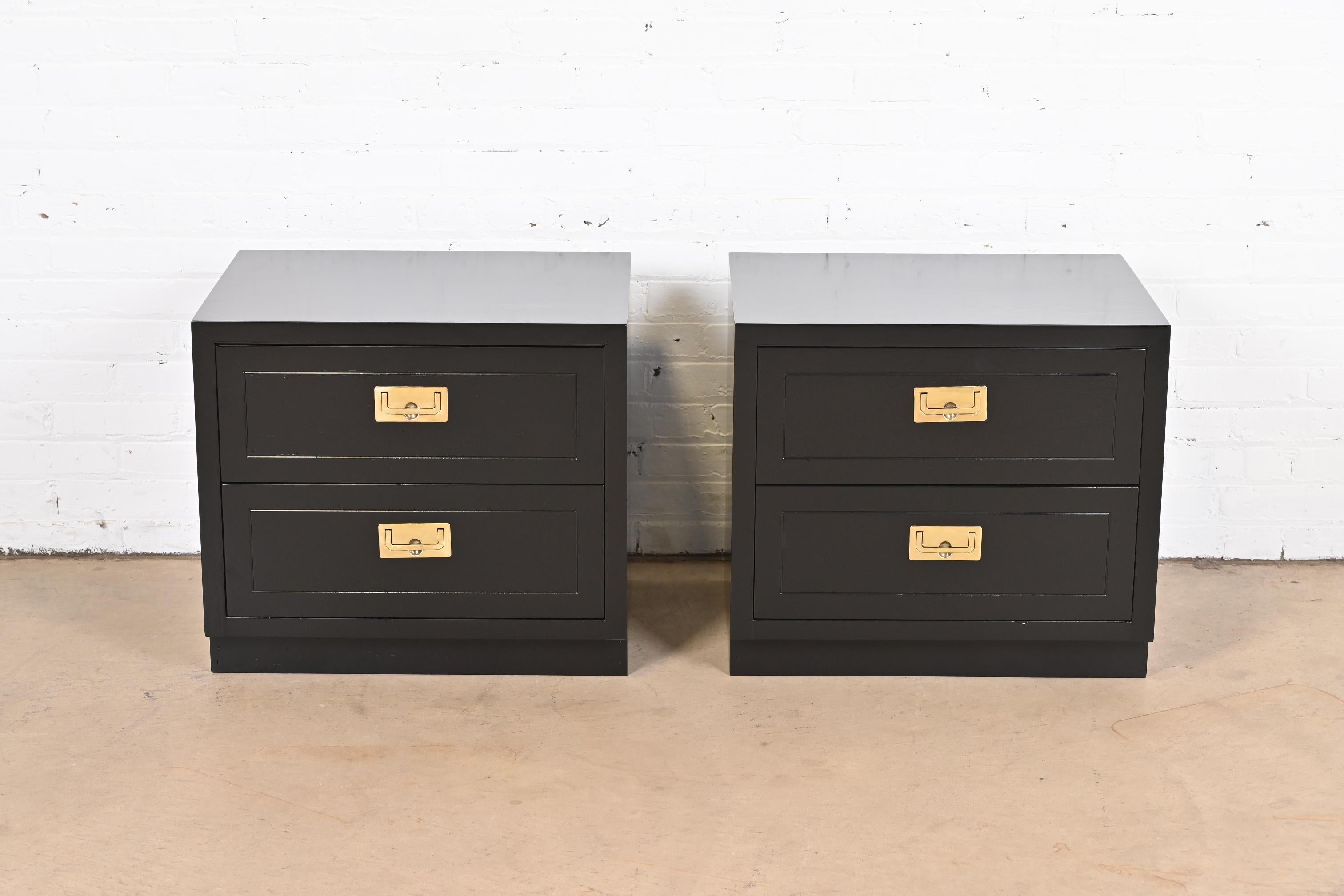 An exceptional pair of mid-century modern Hollywood Regency Campaign style two-drawer nightstands or bedside chests

By Henredon

USA, Circa 1970s

Black lacquered walnut, with original brass hardware.

Measures: 24