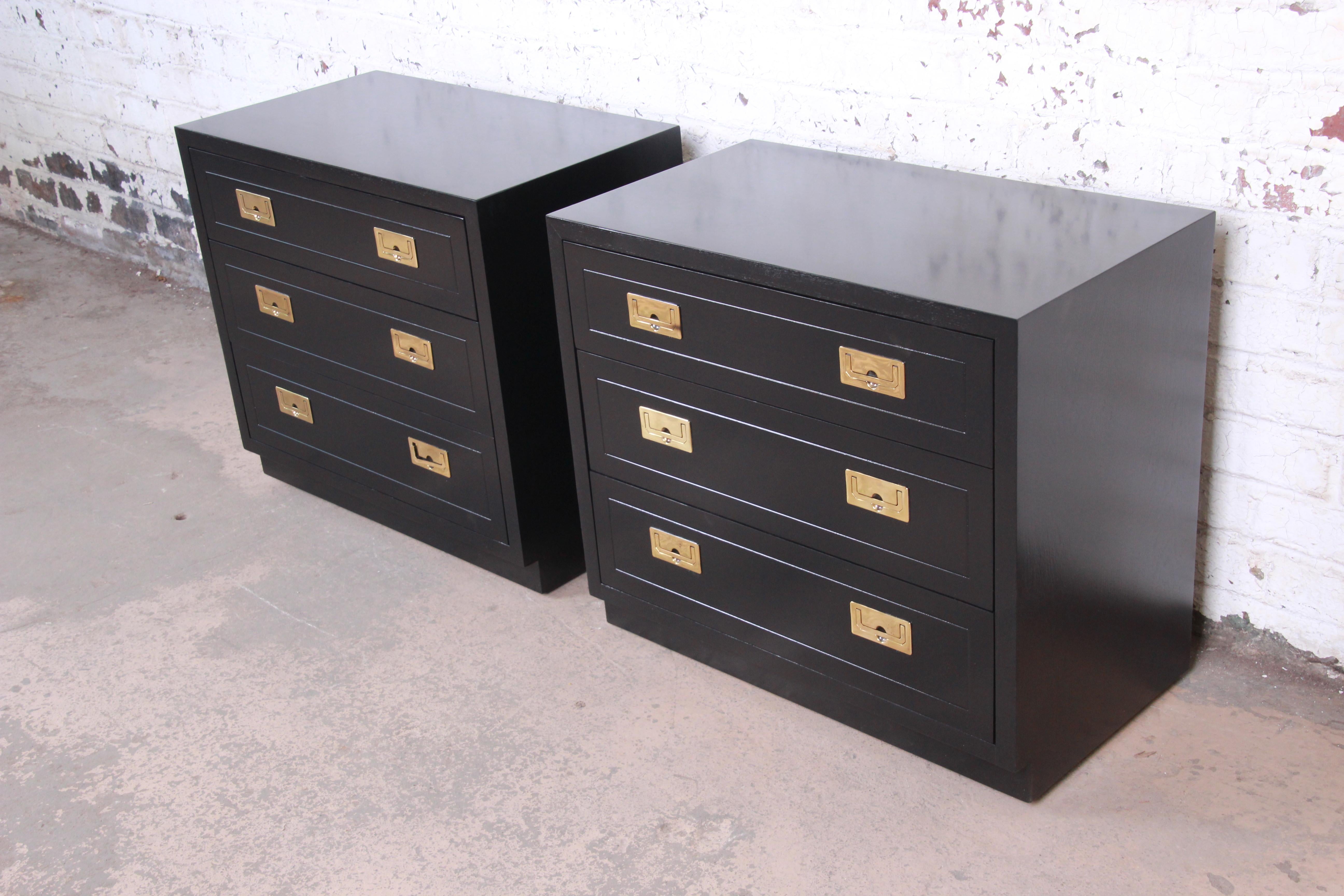 A gorgeous pair of Hollywood Regency Campaign style bachelor chests or nightstands

By Henredon

USA, circa 1970s

Black lacquered walnut, with original brass hardware.

Measures: 32
