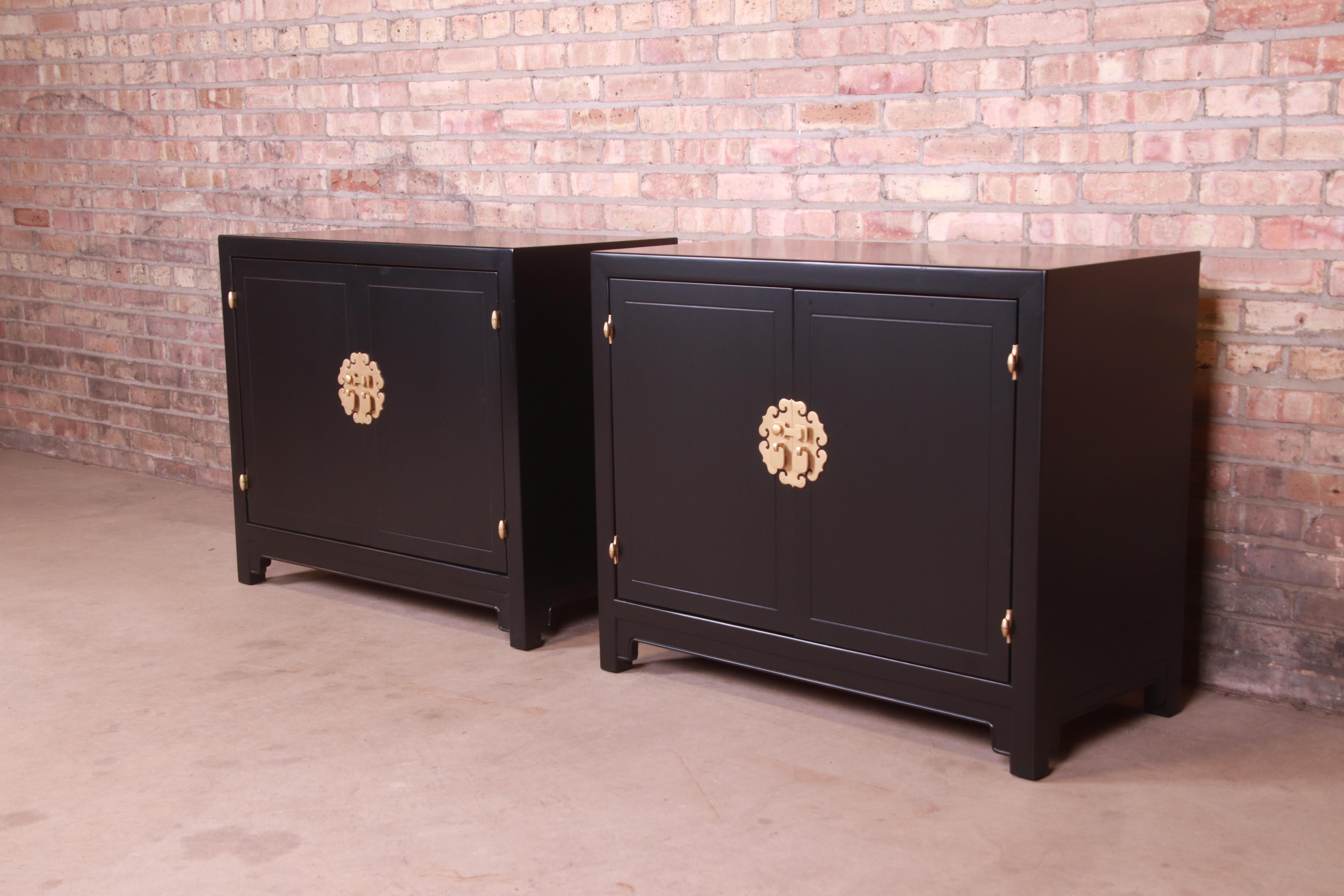 An exceptional pair of Mid-Century Modern Hollywood Regency Chinoiserie compact credenzas, sideboard buffets, or bar cabinets

By Henredon

USA, 1970s

Black lacquered walnut, with original Asian-inspired brass hardware.

Measures: 36