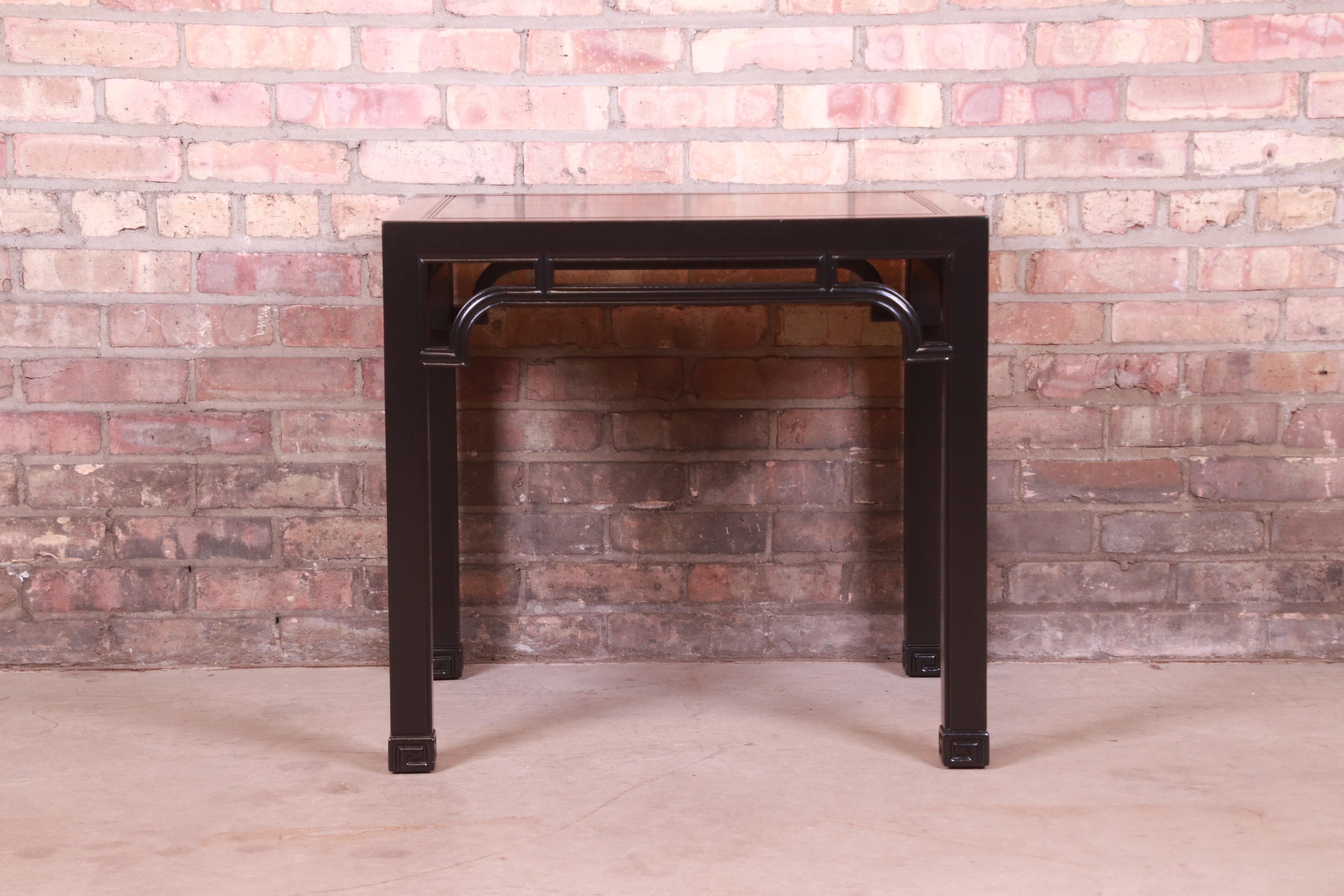 A gorgeous mid-century modern Hollywood Regency Chinoiserie tea table or occasional side table

Attributed to Henredon

USA, Circa 1970s

Black lacquered sculpted walnut, with carved Asian details.

Measures: 26
