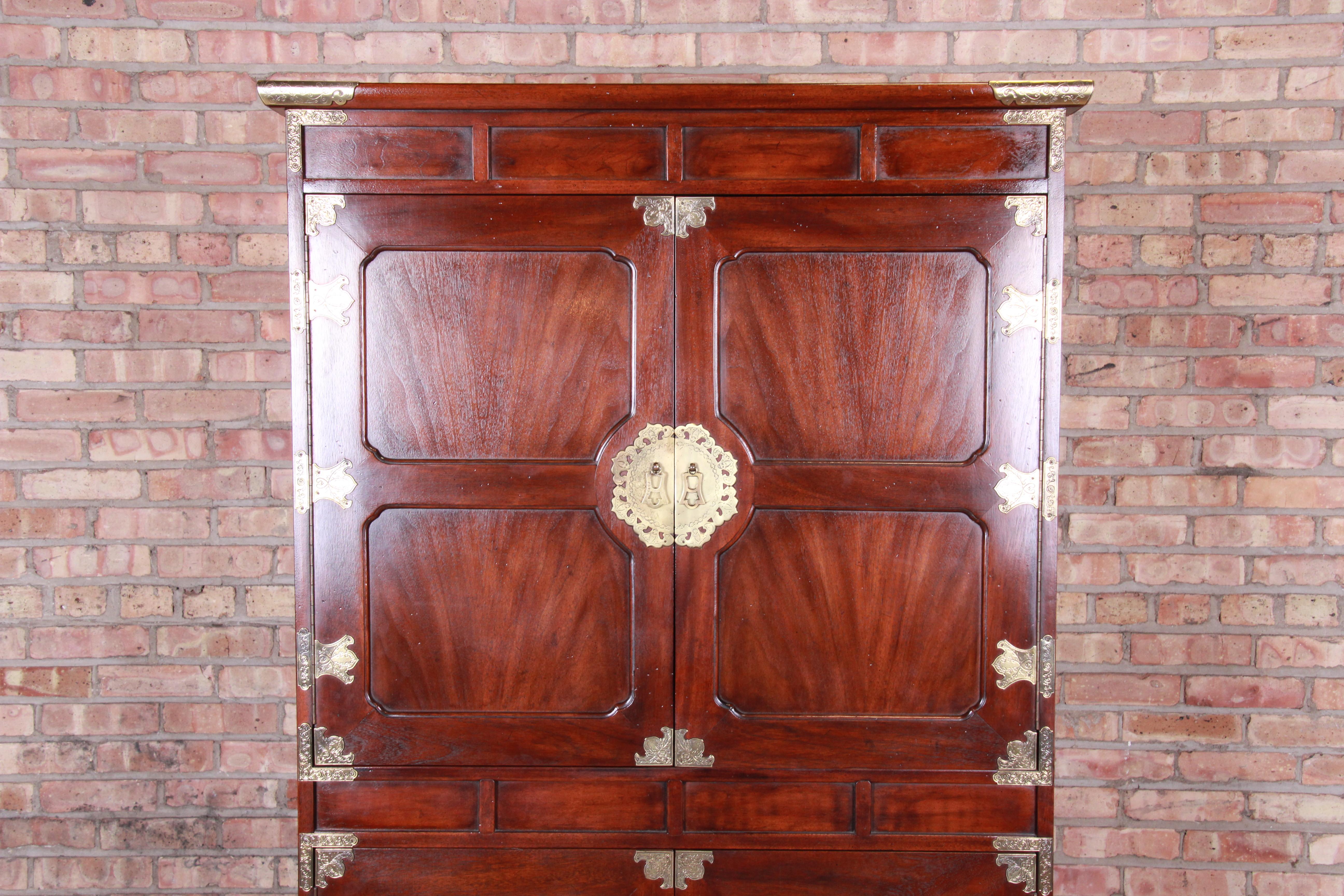 An exceptional midcentury Hollywood Regency chinoiserie armoire dresser or gentleman's chest

By Henredon

USA, 1970s

Bookmatched mahogany, with Asian-inspired etched brass hardware and accents.

Measures: 40.25