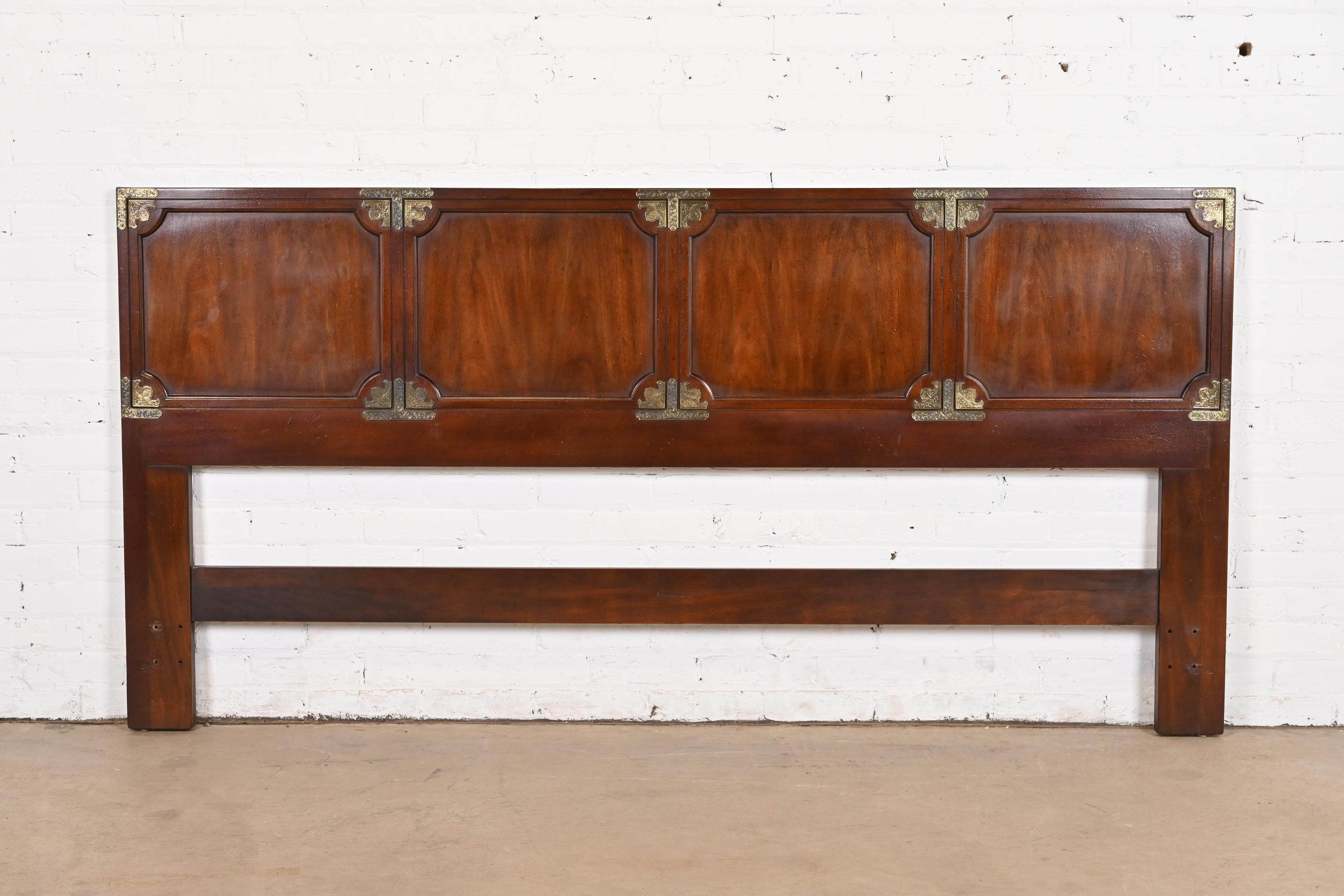 A gorgeous Mid-Century Modern Hollywood Regency Chinoiserie king size headboard

By Henredon

USA, Circa 1960s

Book-matched mahogany, with Asian-inspired brass mounts.

Measures: 79