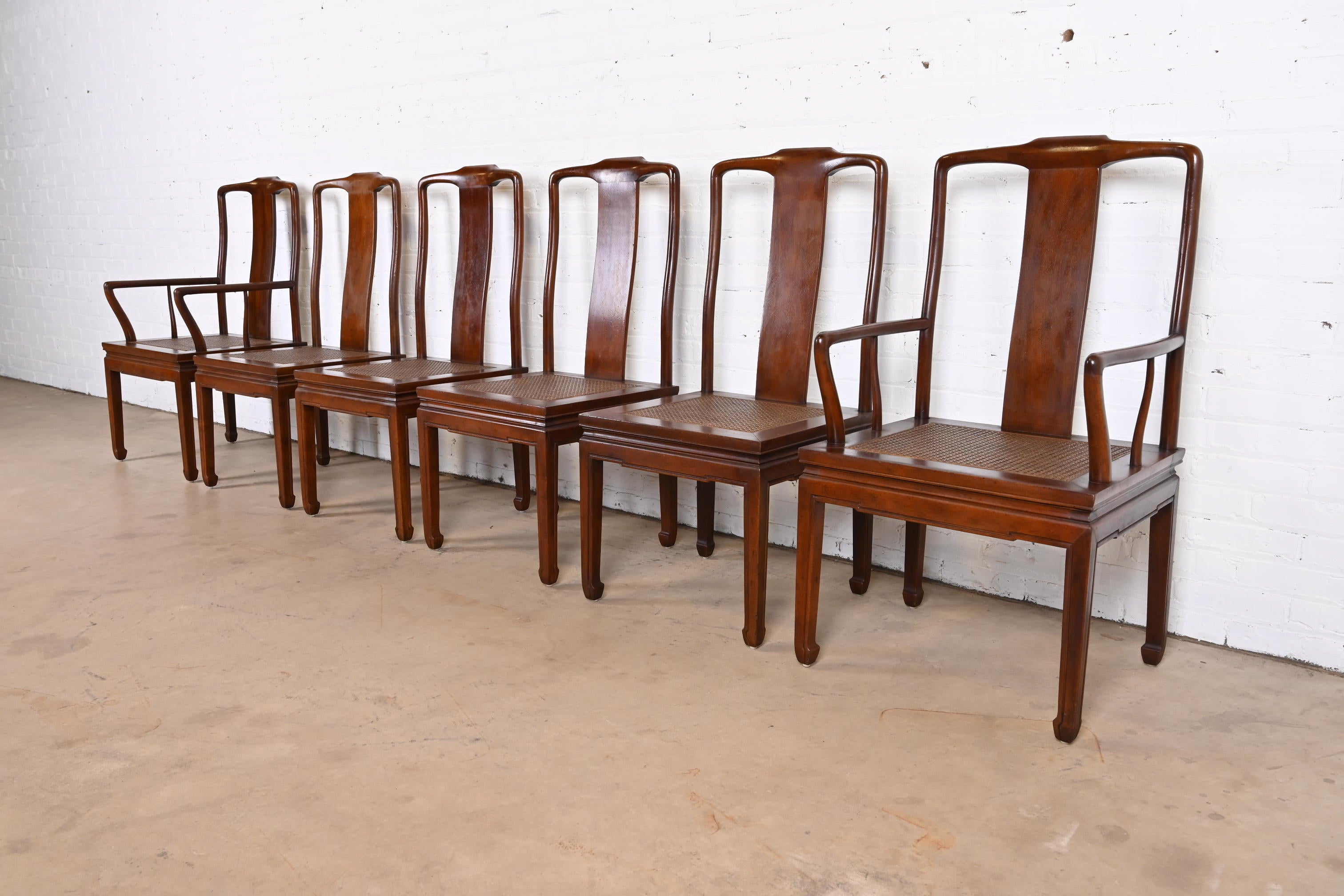A gorgeous set of six mid-century modern Hollywood Regency Chinoiserie dining chairs

By Henredon

USA, Circa 1970s

Solid carved mahogany frames, with caned seats.

Measures:
Side chairs - 19.5″W x 22″D x 40.5″H. Seat height: 17.5″H
Armchairs -