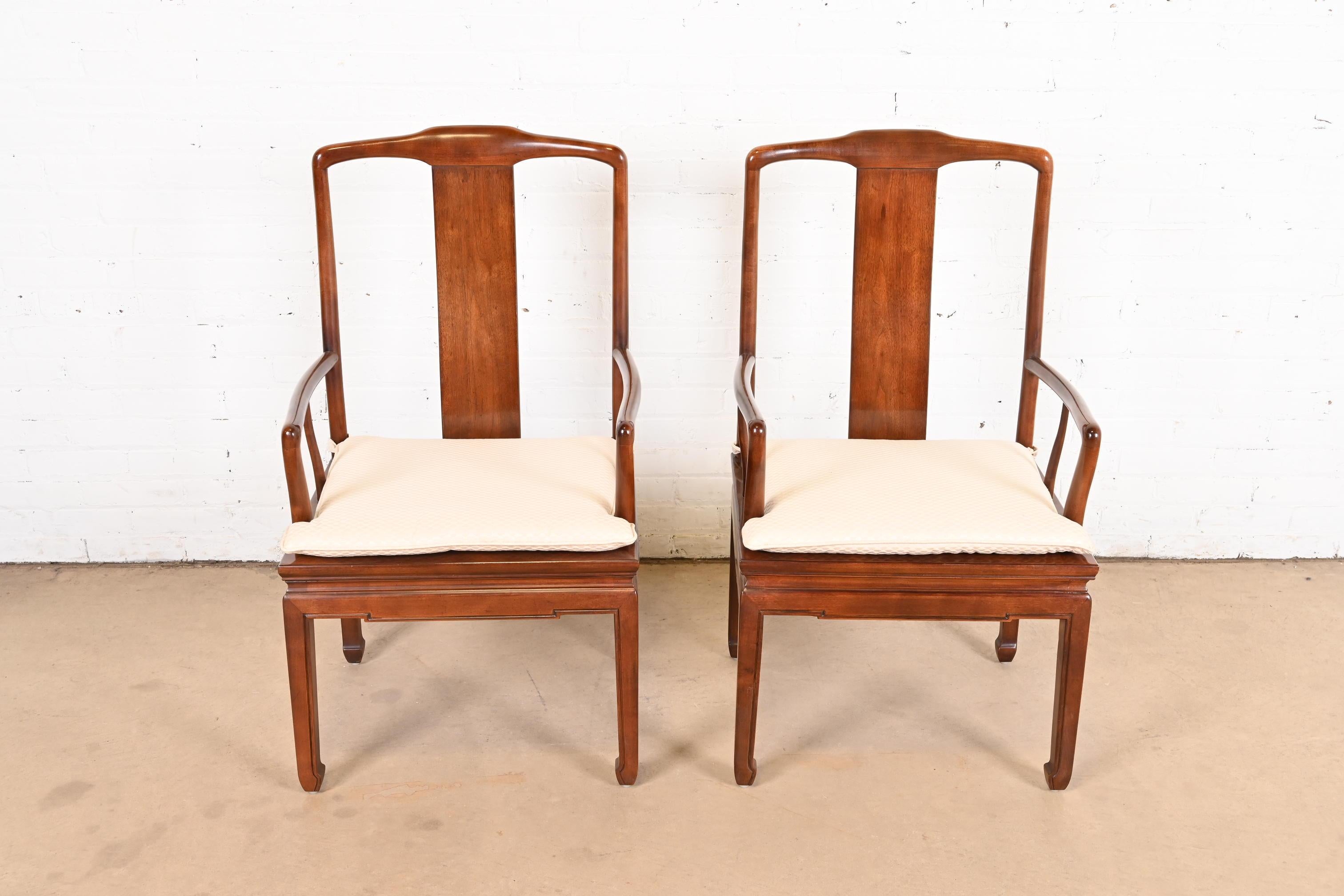 A gorgeous pair of mid-century modern Hollywood Regency Chinoiserie dining arm chairs

By Henredon

USA, Circa 1970s

Solid carved mahogany frames, with caned seats and upholstered seat cushions.

Measures: 22.5