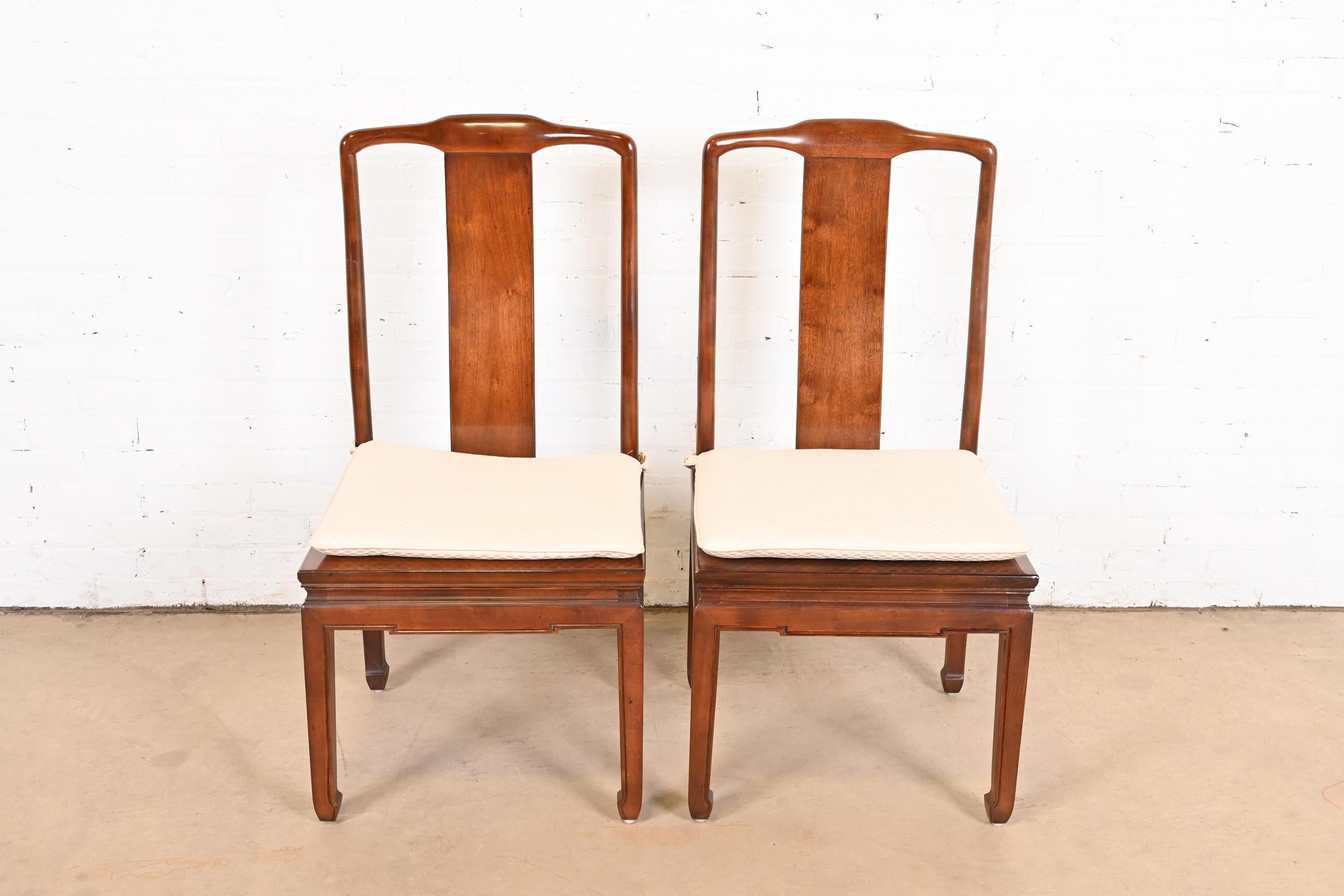 A gorgeous pair of mid-century modern Hollywood Regency Chinoiserie dining chairs

By Henredon

USA, Circa 1970s

Solid carved mahogany frames, with caned seats and upholstered seat cushions.

Measures: 19.5