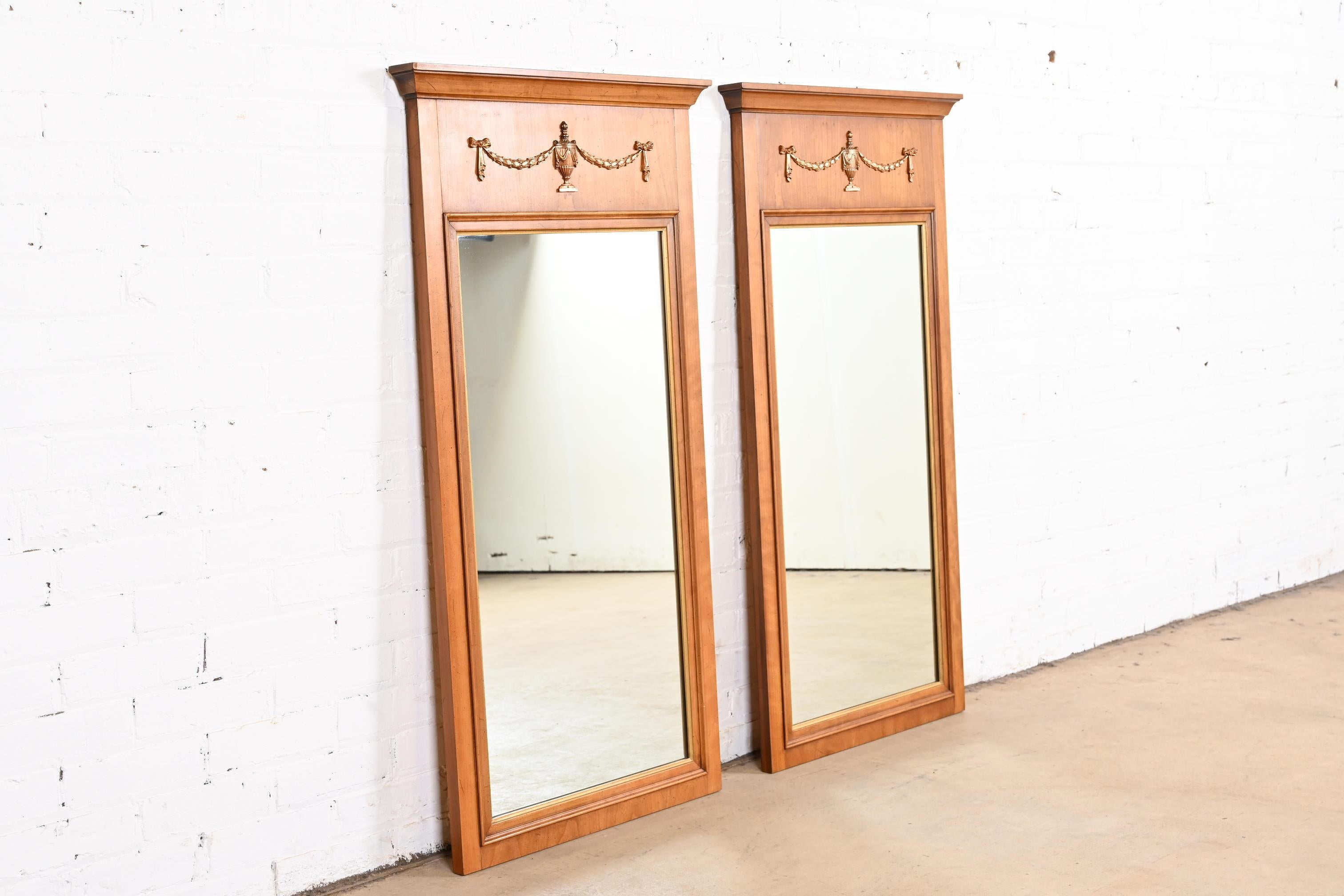 A gorgeous pair of French Regency Louis XVI or Neoclassical style framed wall mirrors

By Henredon

USA, Circa 1960s

Carved cherry wood frames, with gold gilt trim and mounted brass ormolu.

Measures: 24.25