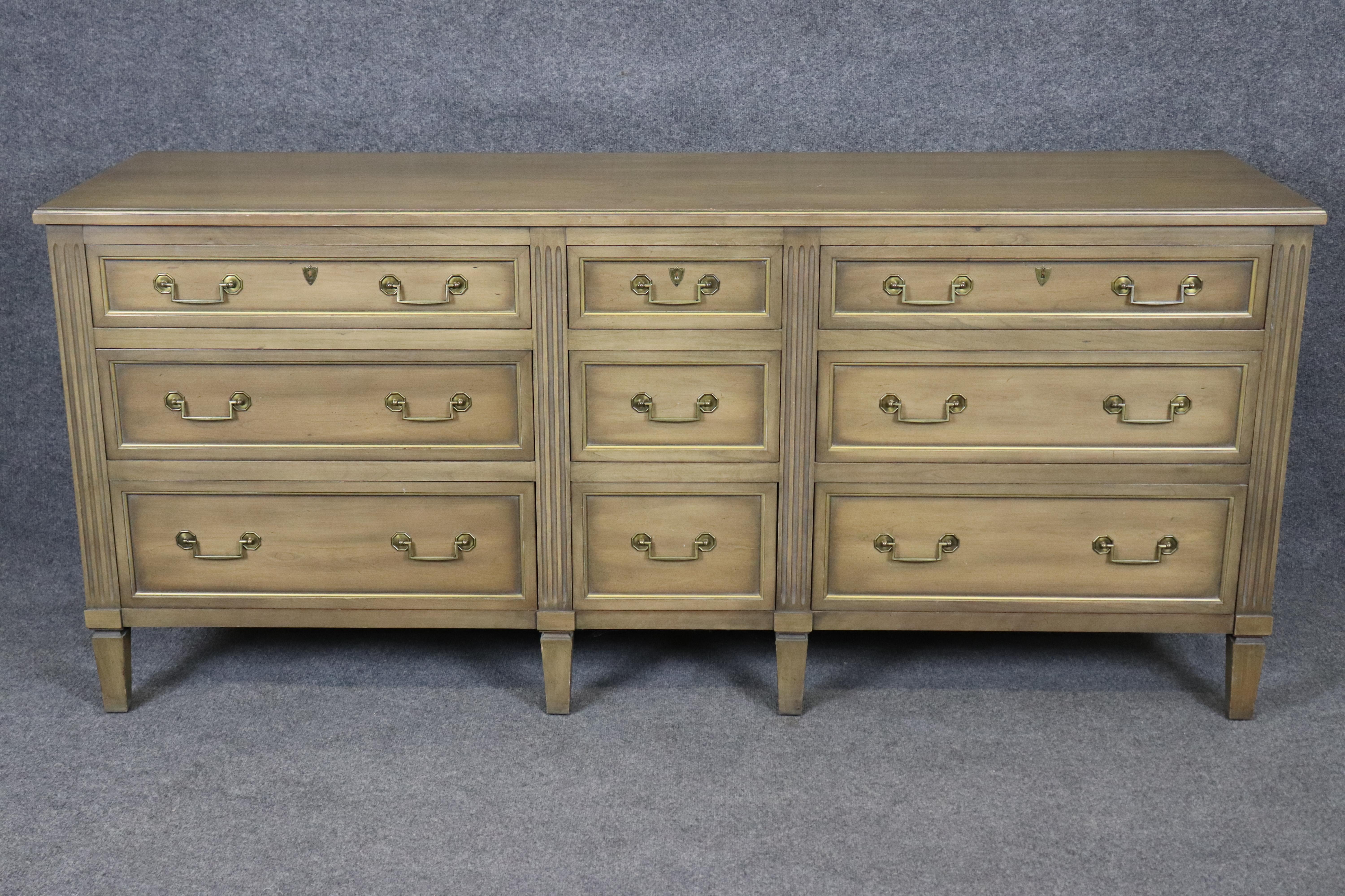 Dimensions - H: 33 1/4 in W: 36 in D: 19 1/4 in 

Elevate your interior with this exquisite Henredon nine-drawer dresser, a sophisticated piece from the renowned Henredon Heritage Collection, expertly crafted in the refined Louis XVI / Directoire