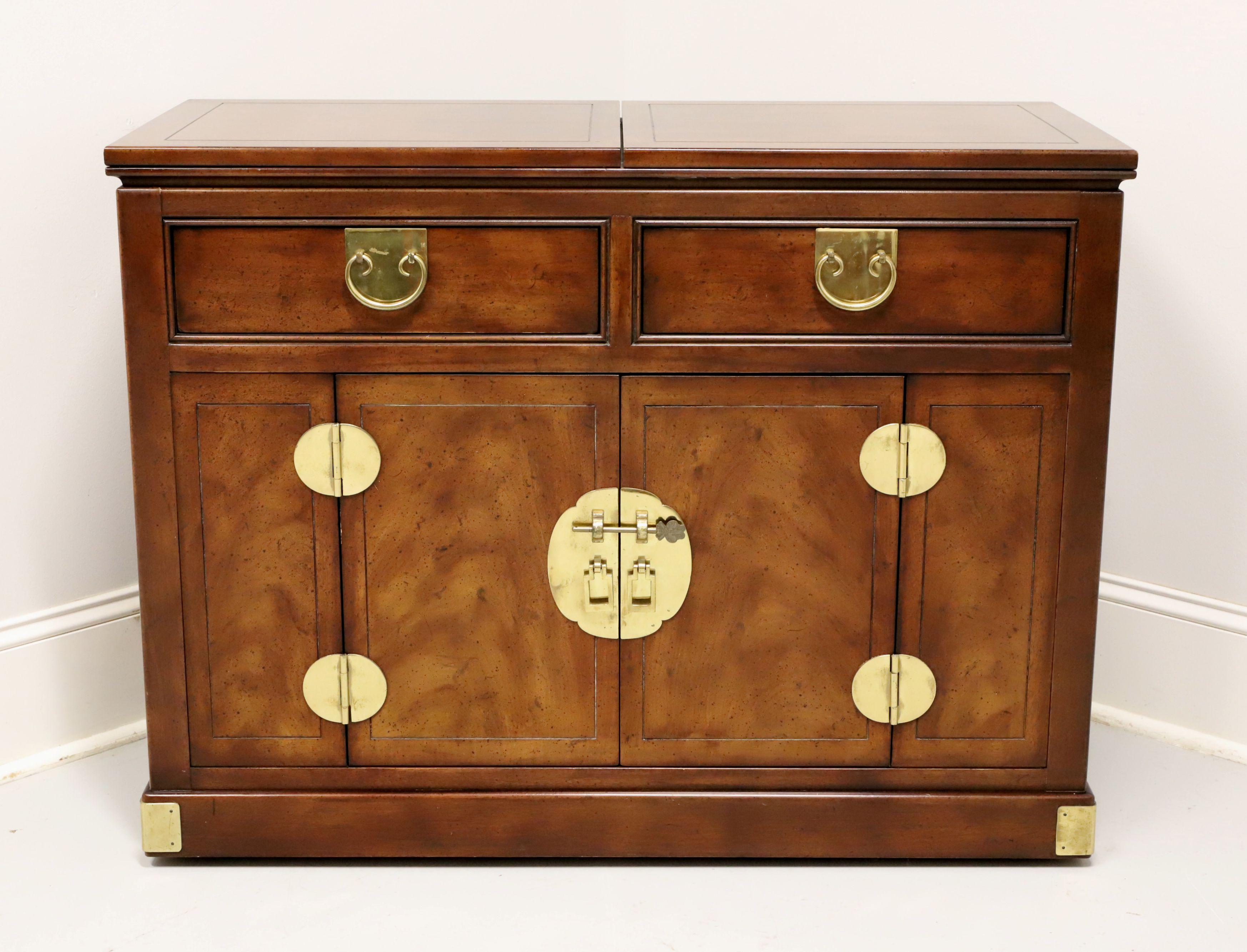 An Asian Chinoiserie style server by Henredon. Mahogany, composite surface under the flip out top, decorative brass hardware & accents, and on casters. Features two drawers of dovetail construction over a two door cabinet revealing a storage area