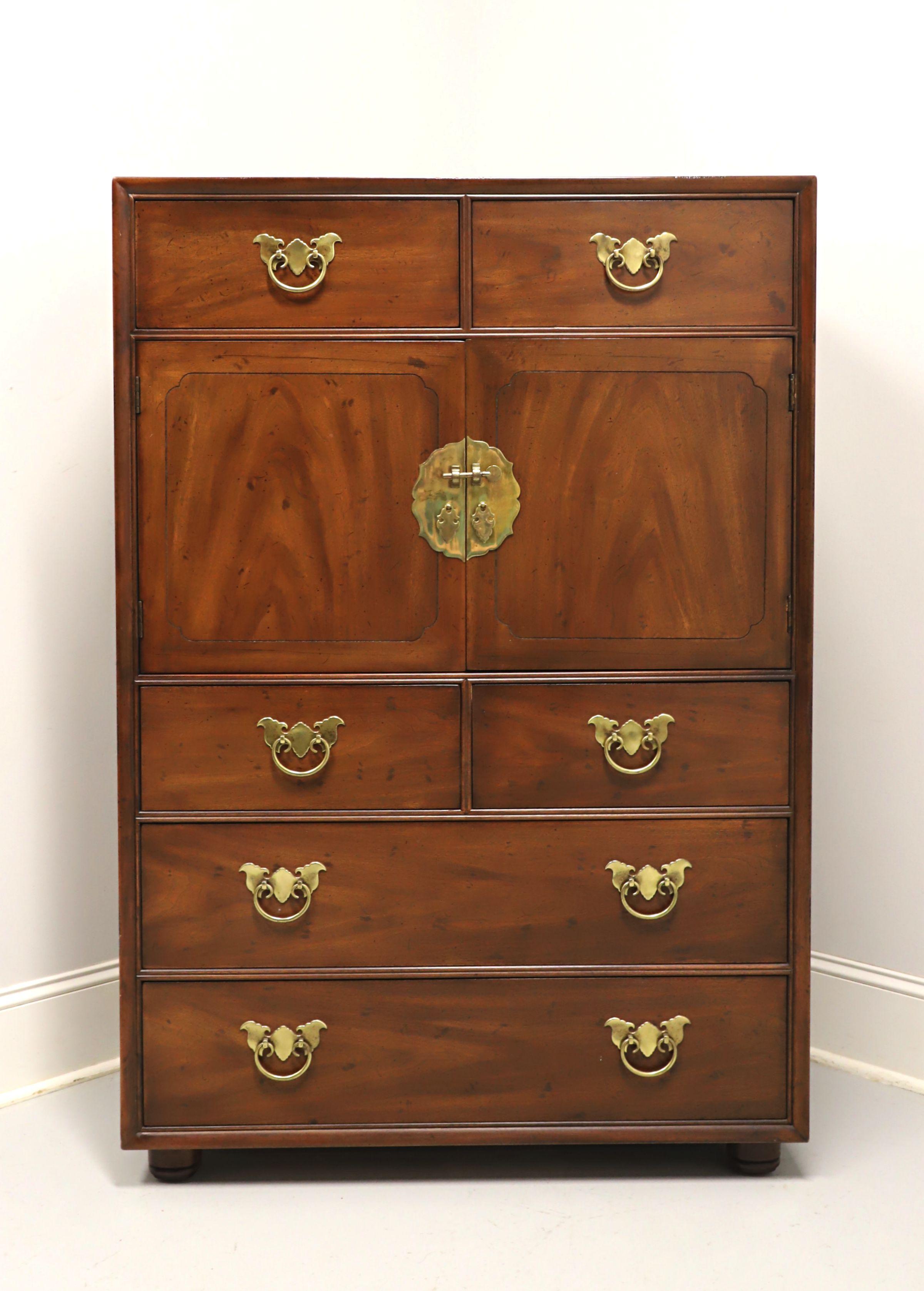 An Asian chinoiserie style gentleman's chest by Henredon. Mahogany with slightly distressed finish, decorative brass hardware, flame mahogany to door fronts, and bun feet. Features a center two door cabinet revealing an interior of six fixed