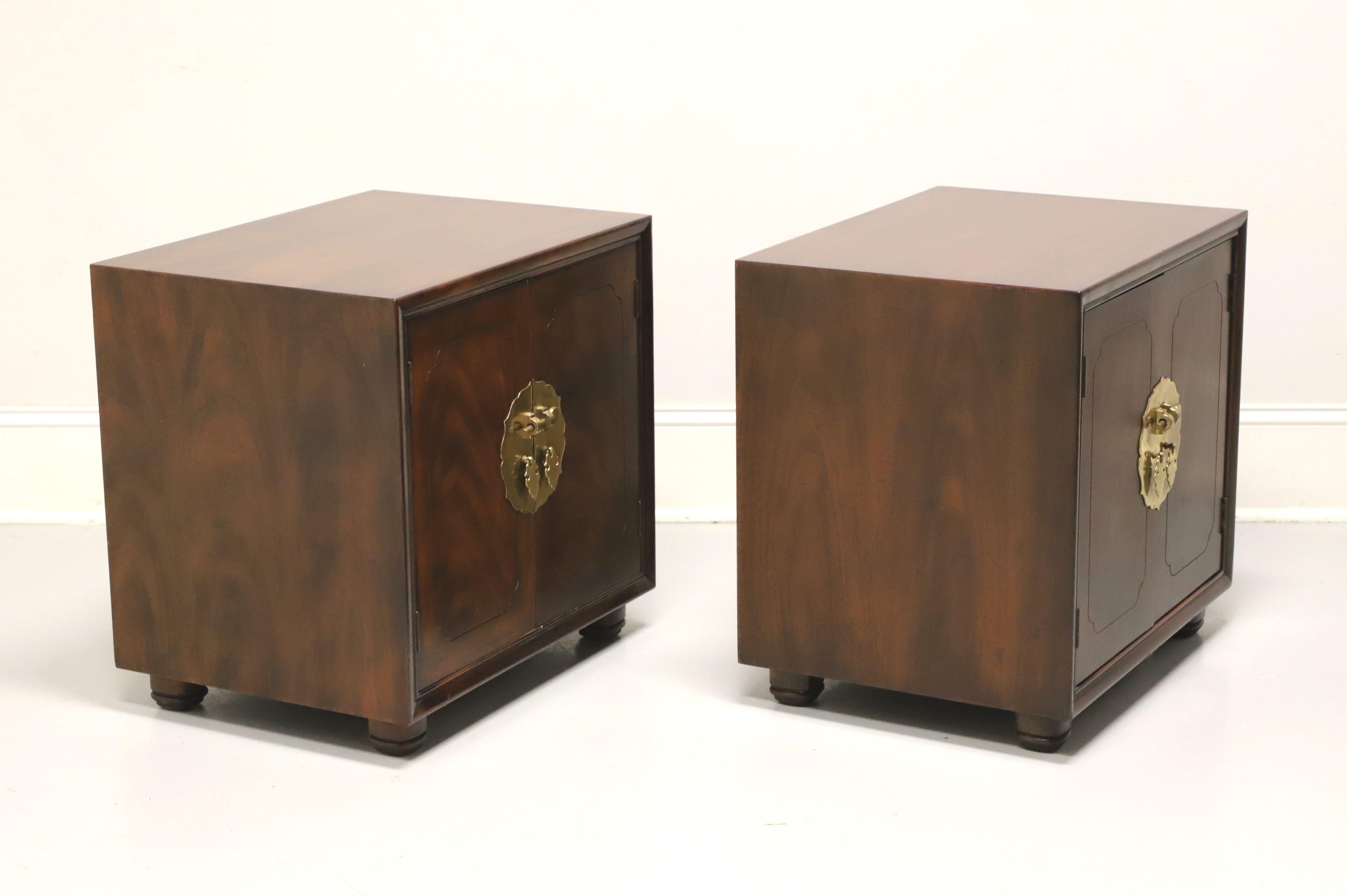 A pair of Asian Chinoiserie style nightstands by Henredon. Mahogany with slightly distressed finish, flame mahogany to door fronts, smooth surface top, brass hardware and bun feet. Features a two door cabinet revealing a storage area with one