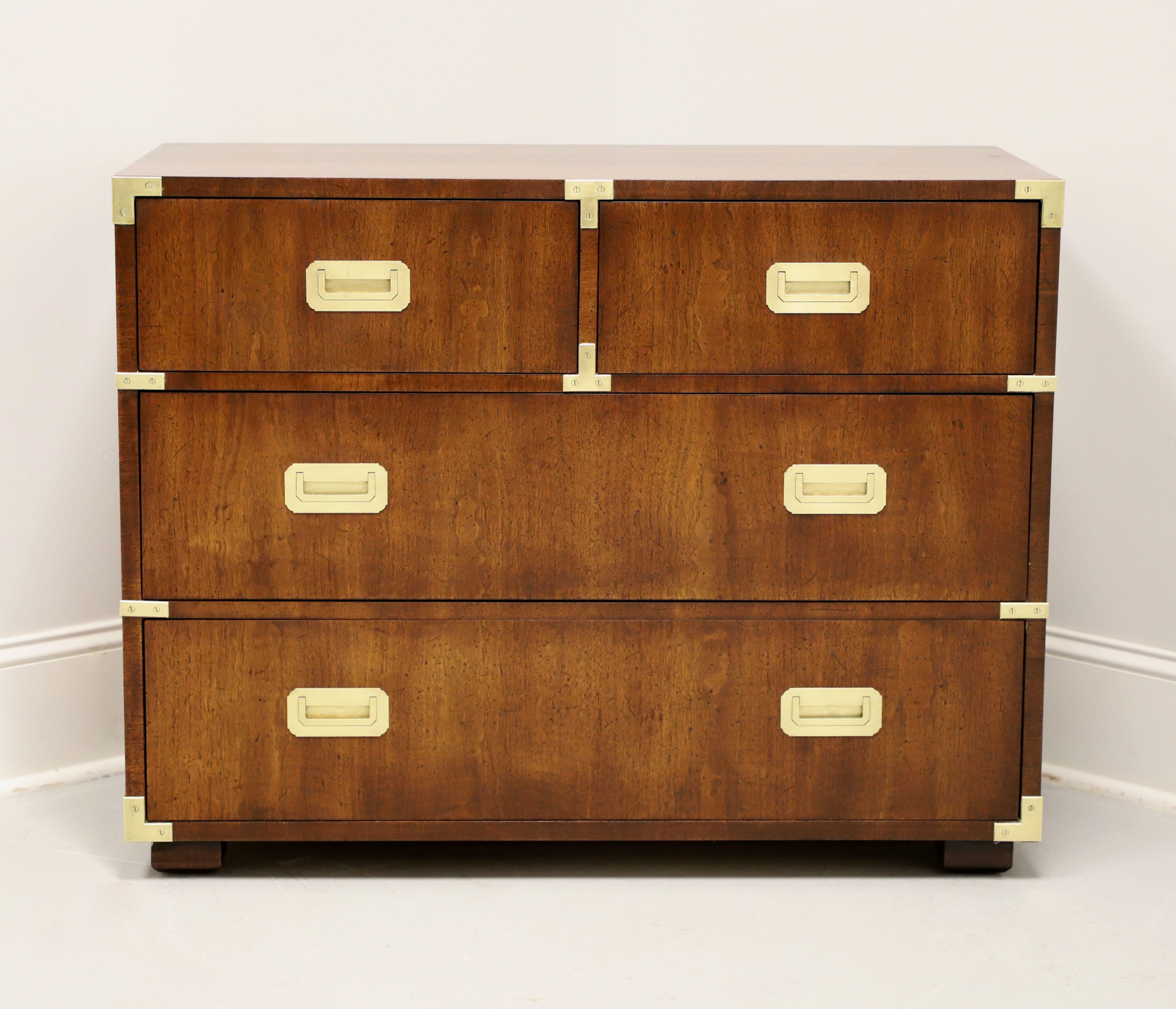 A campaign style bachelor chest by Henredon. Walnut with a slightly distressed finish, brass hardware & accents, smooth edge to top, and block feet. Features two smaller over four larger drawers of dovetail construction with the top right drawer