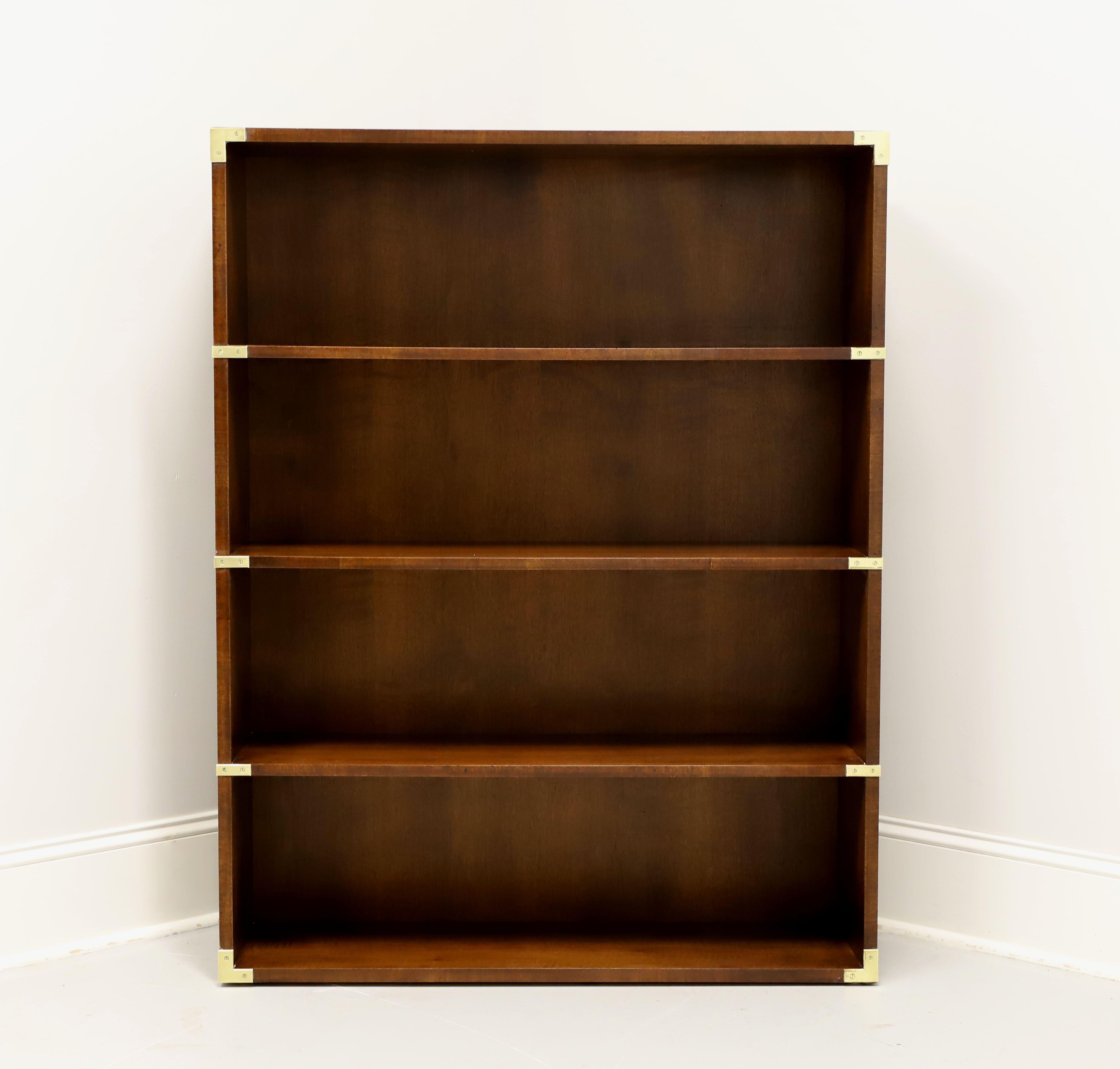 A campaign style open bookcase by Henredon. Walnut with a slightly distressed finish, brass accents, smooth edge to top, and a flat base. Features four fixed shelves with eleven and half inches of height between them. Made in Morganton, North