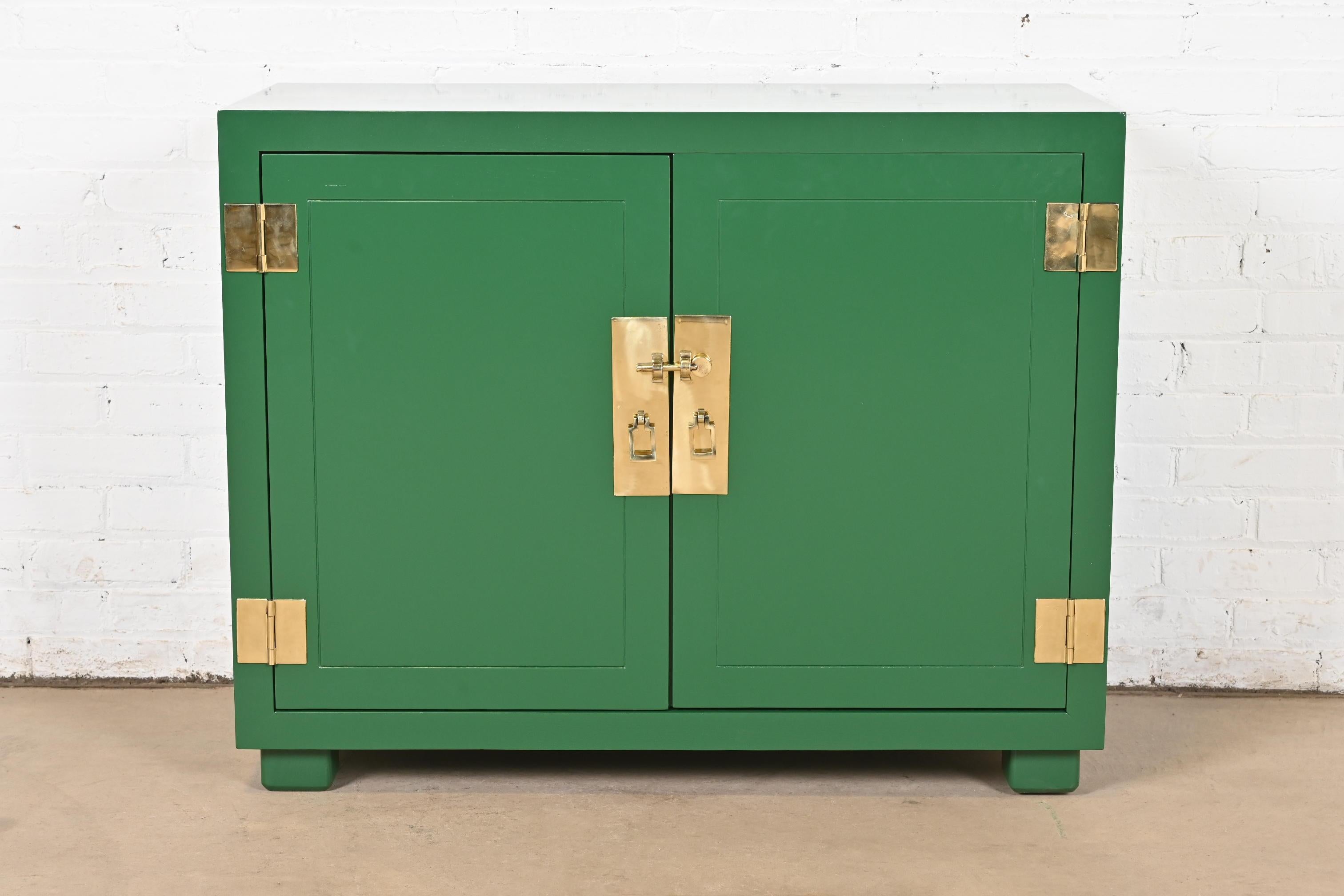An exceptional mid-century modern Hollywood Regency Campaign style buffet server or bar cabinet

By Henredon

USA, Circa 1970s

Green lacquered oak, with original brass hardware.

Measures: 39