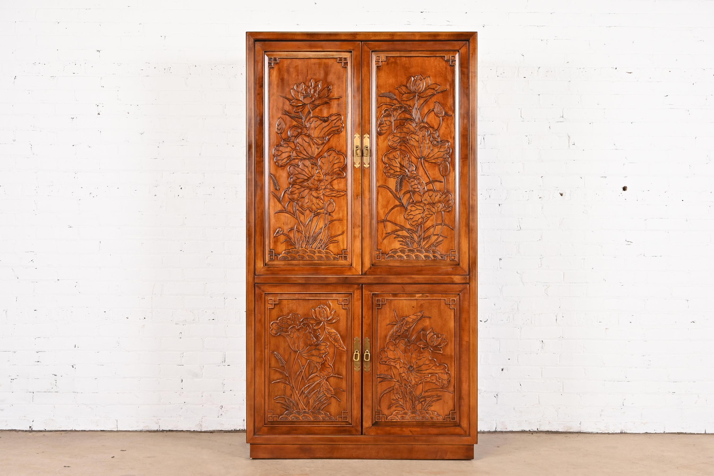 A gorgeous mid-century modern Hollywood Regency Chinoiserie style media cabinet, armoire, or bar cabinet

By Henredon

USA, Circa 1970s

Carved walnut, with original brass hardware.

Measures: 40