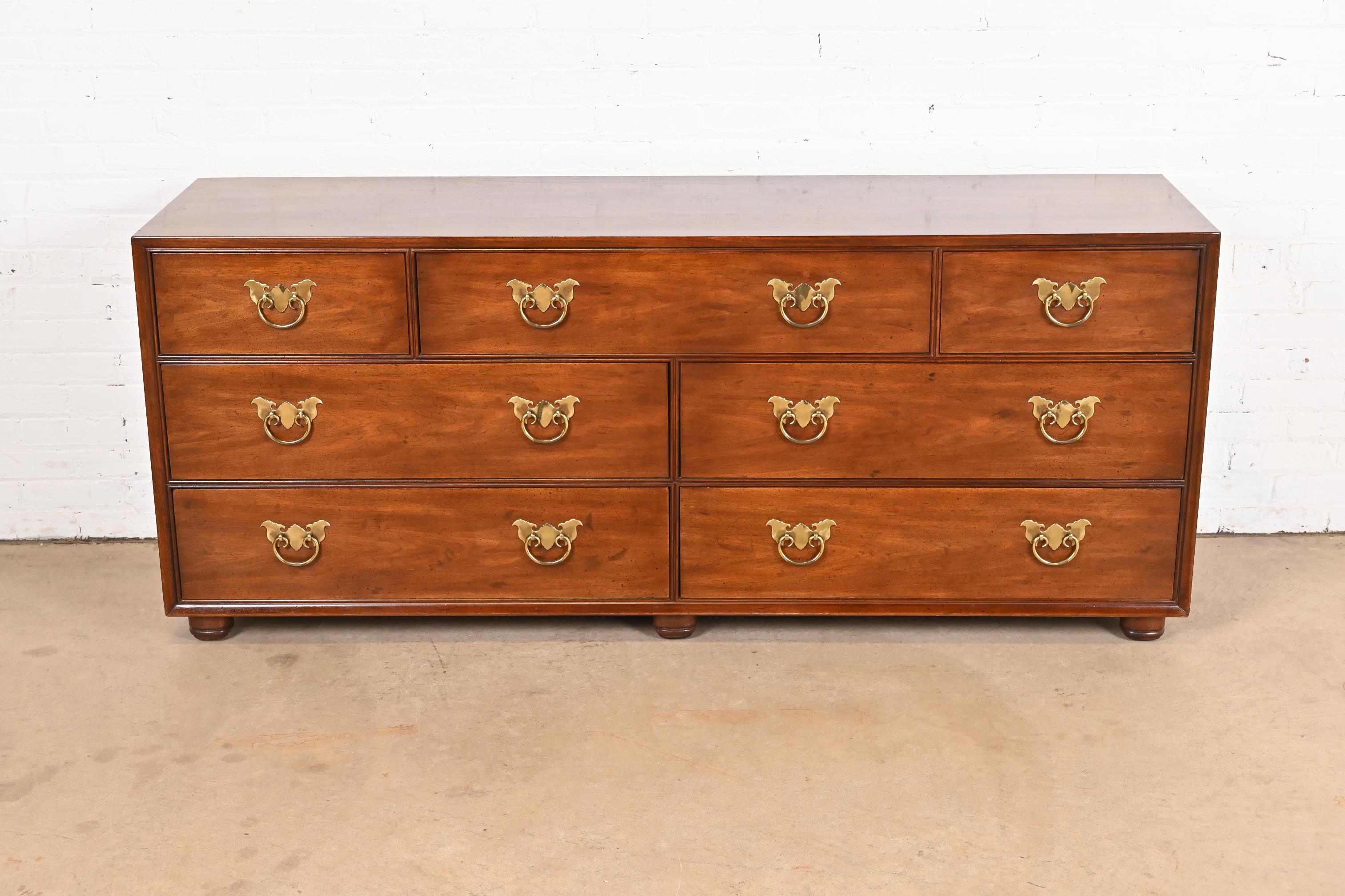 Uno splendido comò o credenza a sette cassetti in stile Hollywood Regency moderno di metà secolo

Da Henredon

USA, circa anni '1970

Splendido legno di noce, con ferramenta originale in ottone di ispirazione asiatica.

Misure: 72 
