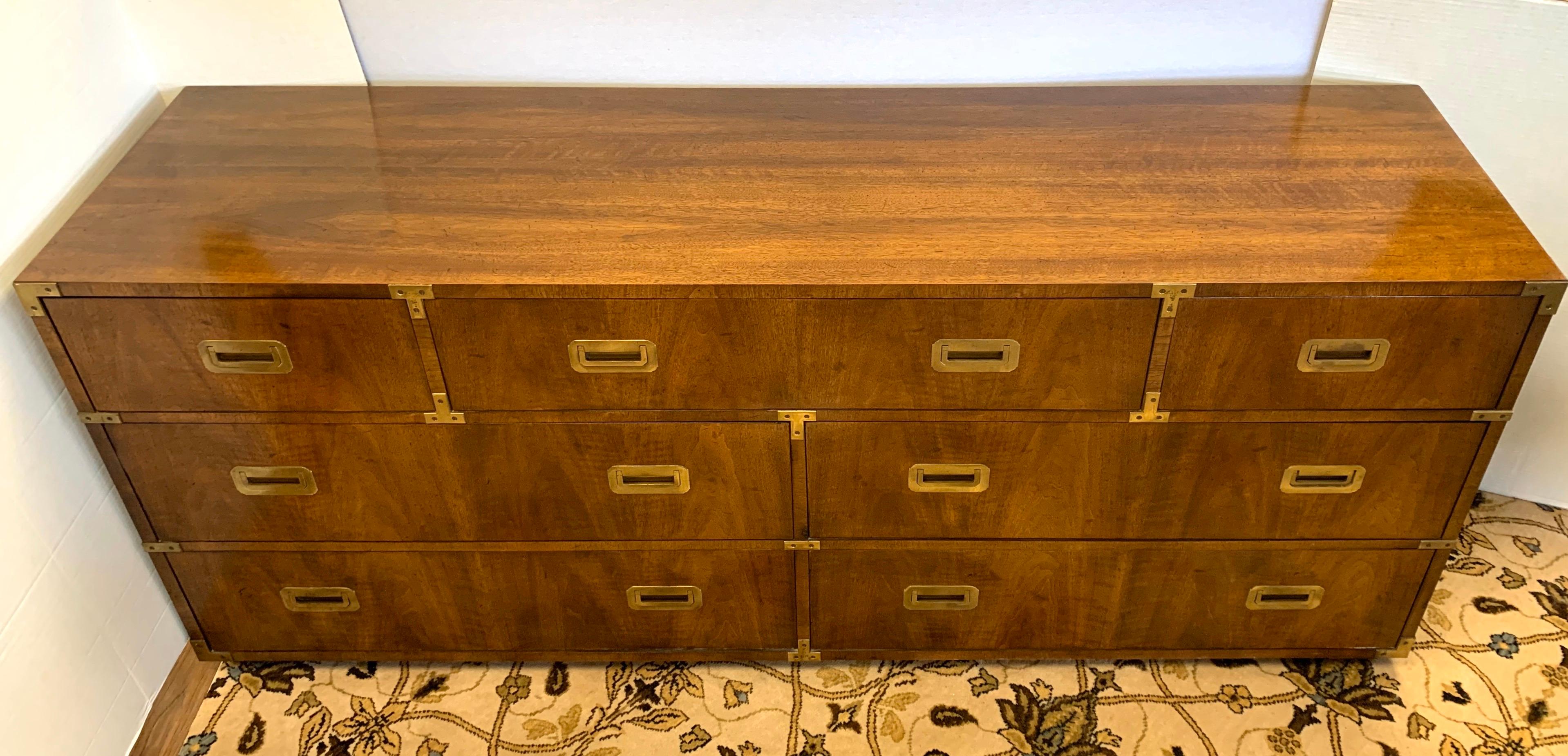 Immense Henredon Campaign dresser with seven spacious dovetailed drawers with original brass hardware. All Henredon hallmarks present. An iconic midcentury classic.