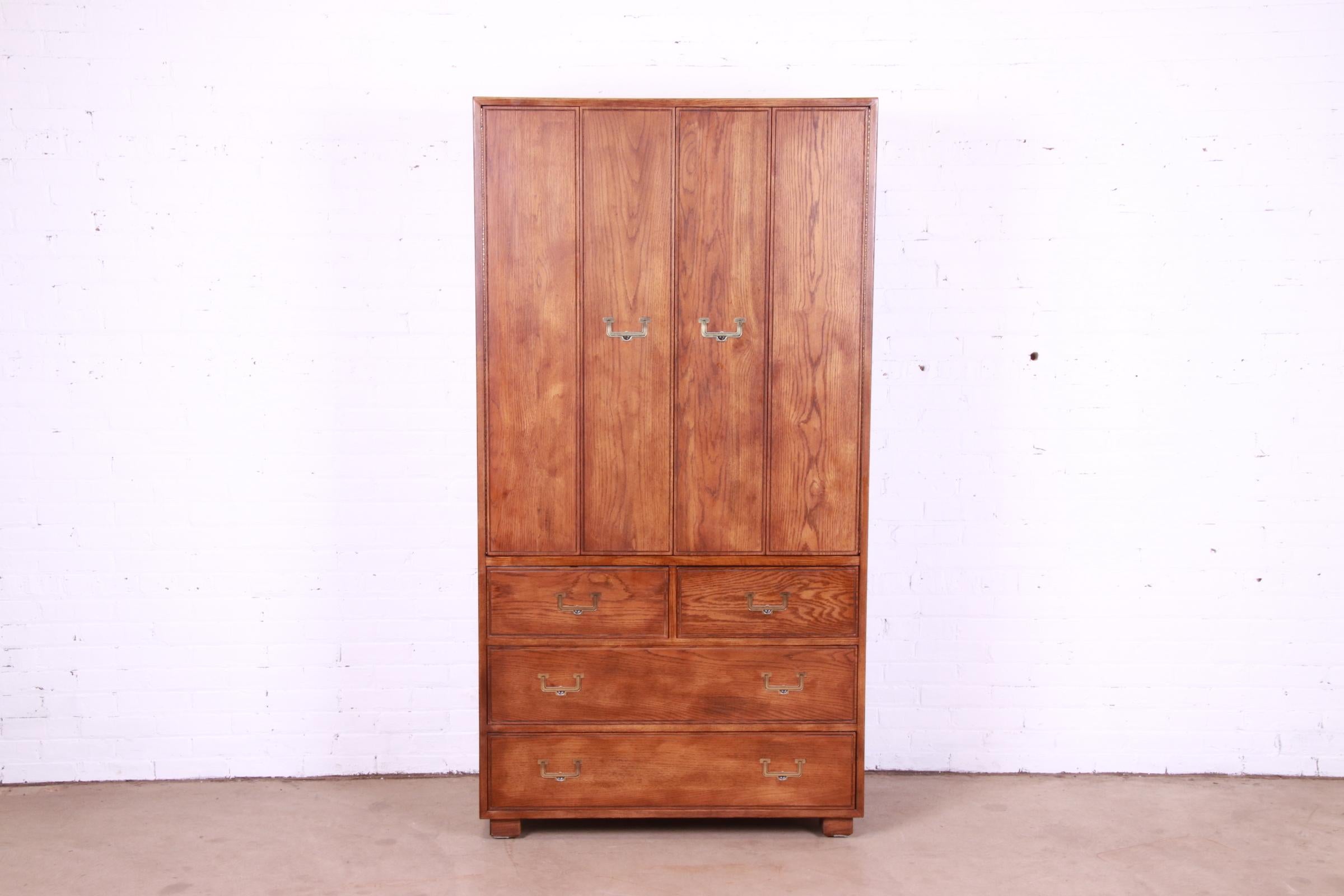 A gorgeous Mid-Century Modern Campaign style gentleman's chest, highboy, or armoire dresser

By Henredon, 