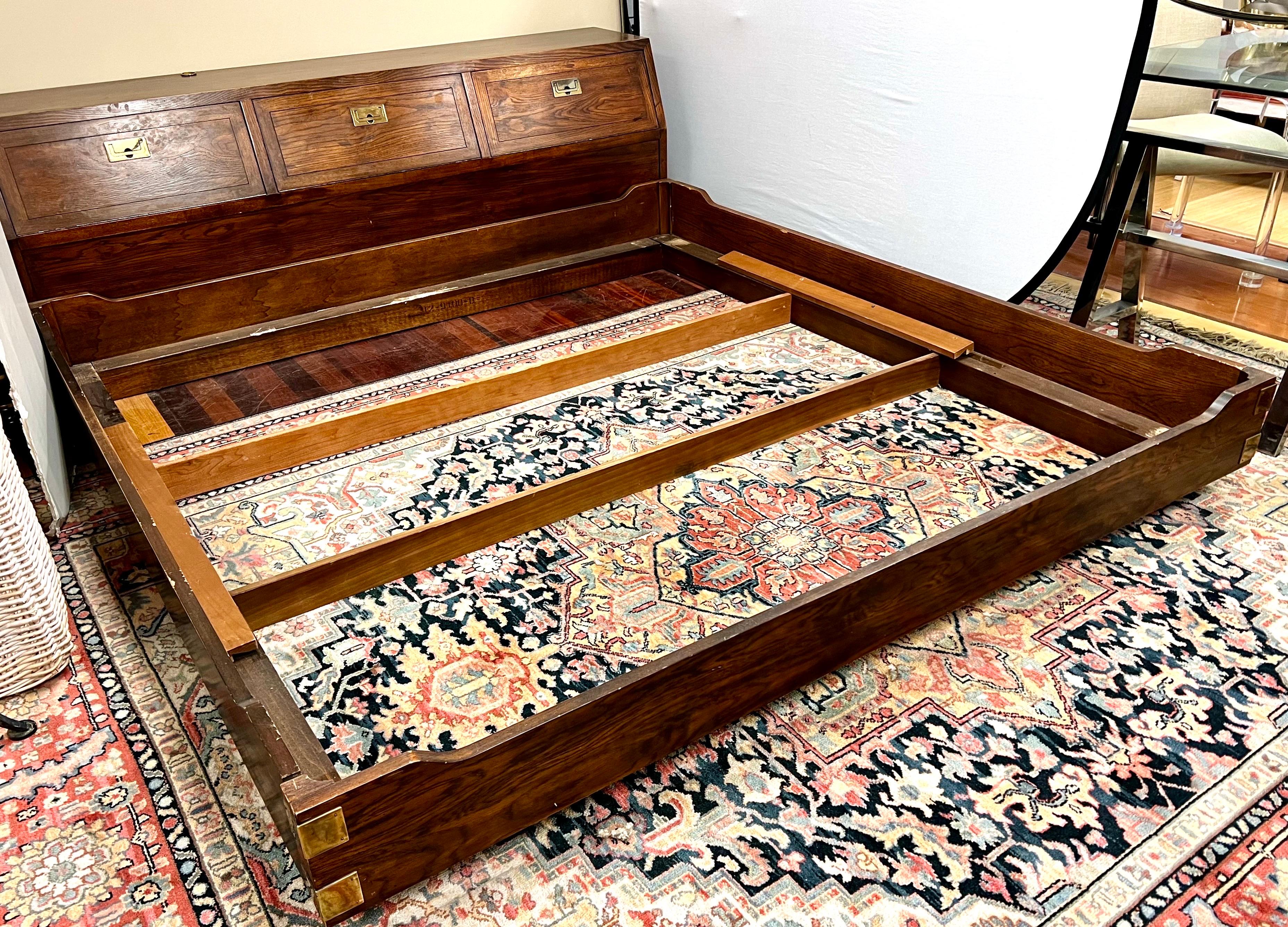 Iconic and coveted Henredon Scene 1 king size bed which features headboard and platform bed.  Easy to put together.  Headboard has three compartments for storage from floor up.  Campaign style at its very best!  All Henredon hallmarks present.