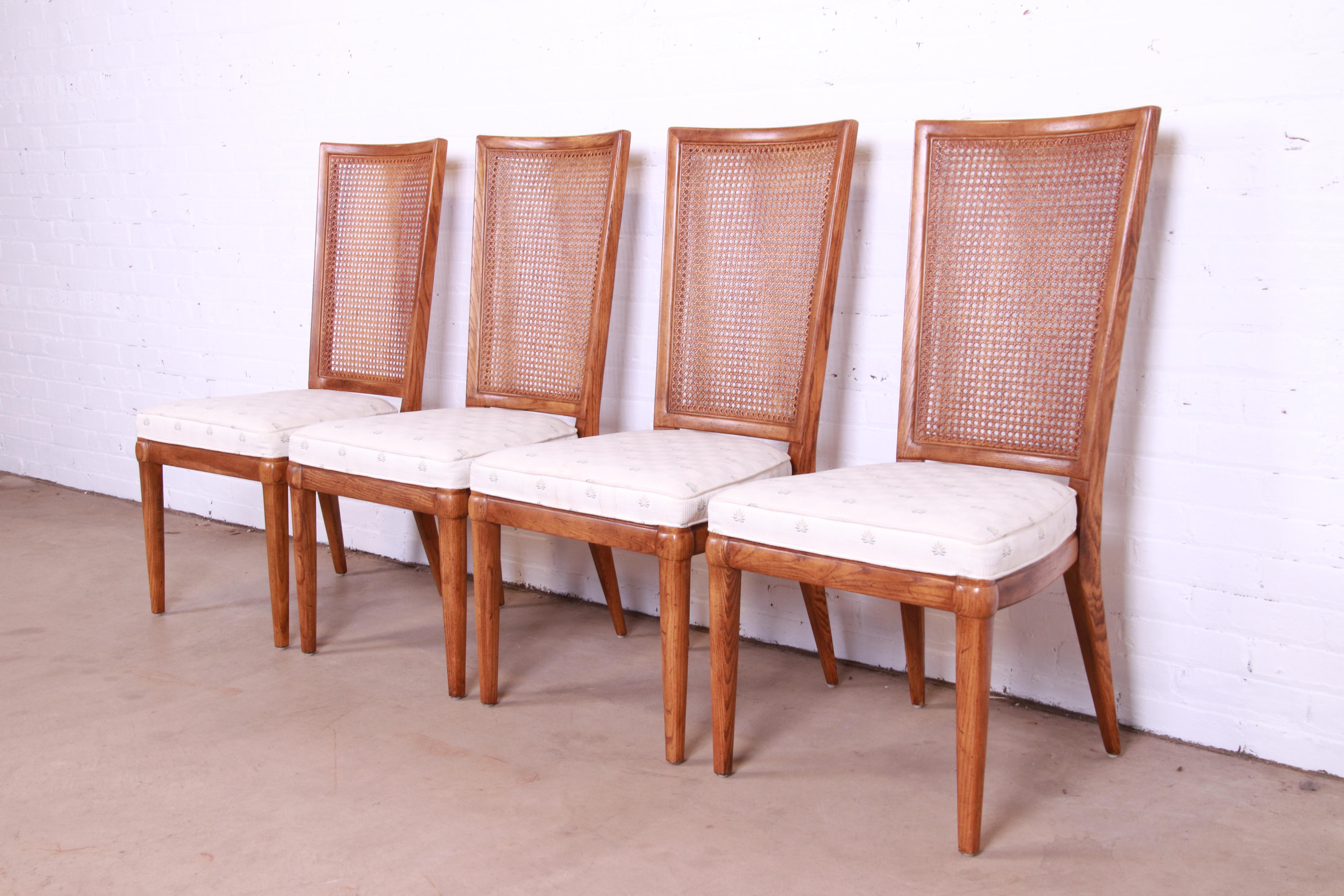 A gorgeous set of four Mid-Century Modern style dining chairs

By Henredon

USA, Circa 1970s

Carved solid oak frames, with caned backs and upholstered seats.

Measures: 20