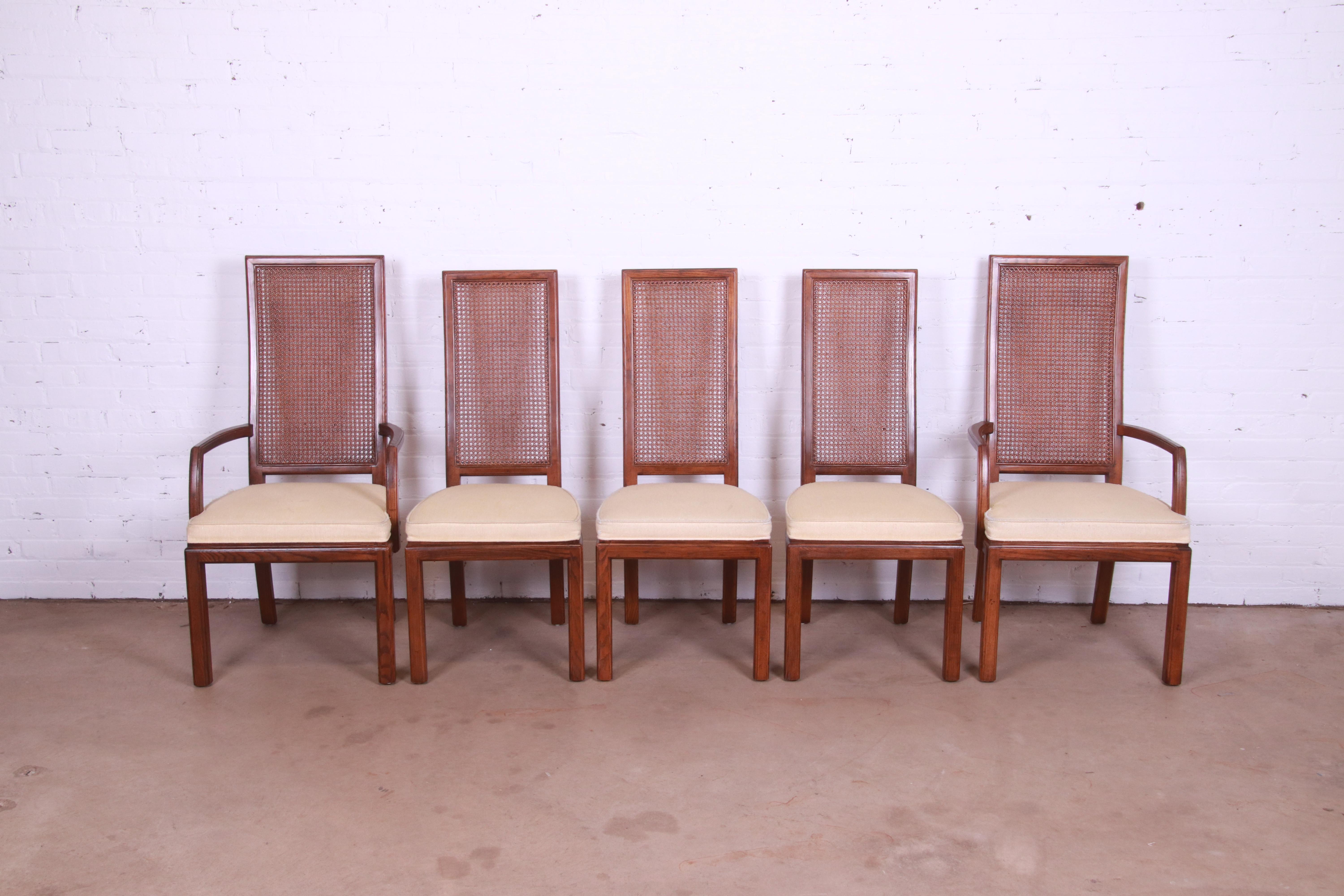 A gorgeous set of five Mid-Century Modern high back dining chairs

By Henredon

USA, Circa 1970s

Oak frames, with cane backs and upholstered seats.

Measures:
Side chairs: 18.75