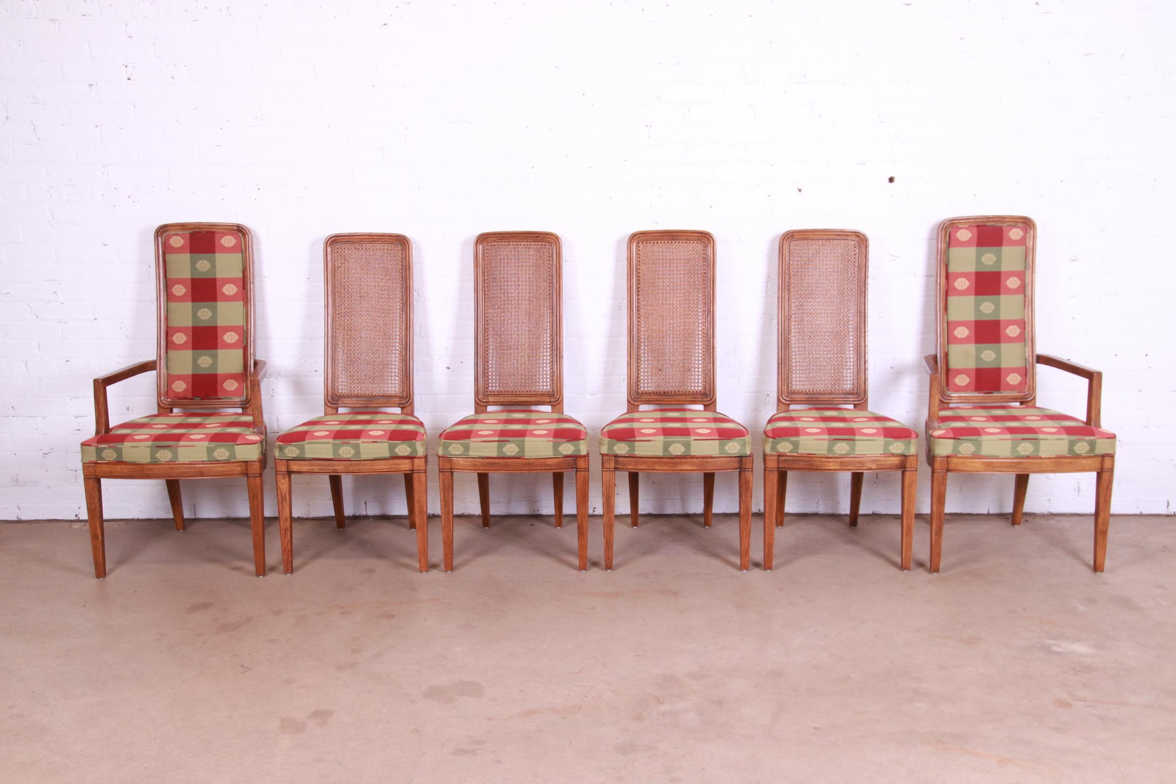 A gorgeous set of six Mid-Century Modern high back dining chairs

By Henredon

USA, Circa 1970s

Oak frames, with cane backs on the side chairs and upholstered seats and backs on the captain chairs.

Measures:
Side chairs: 20