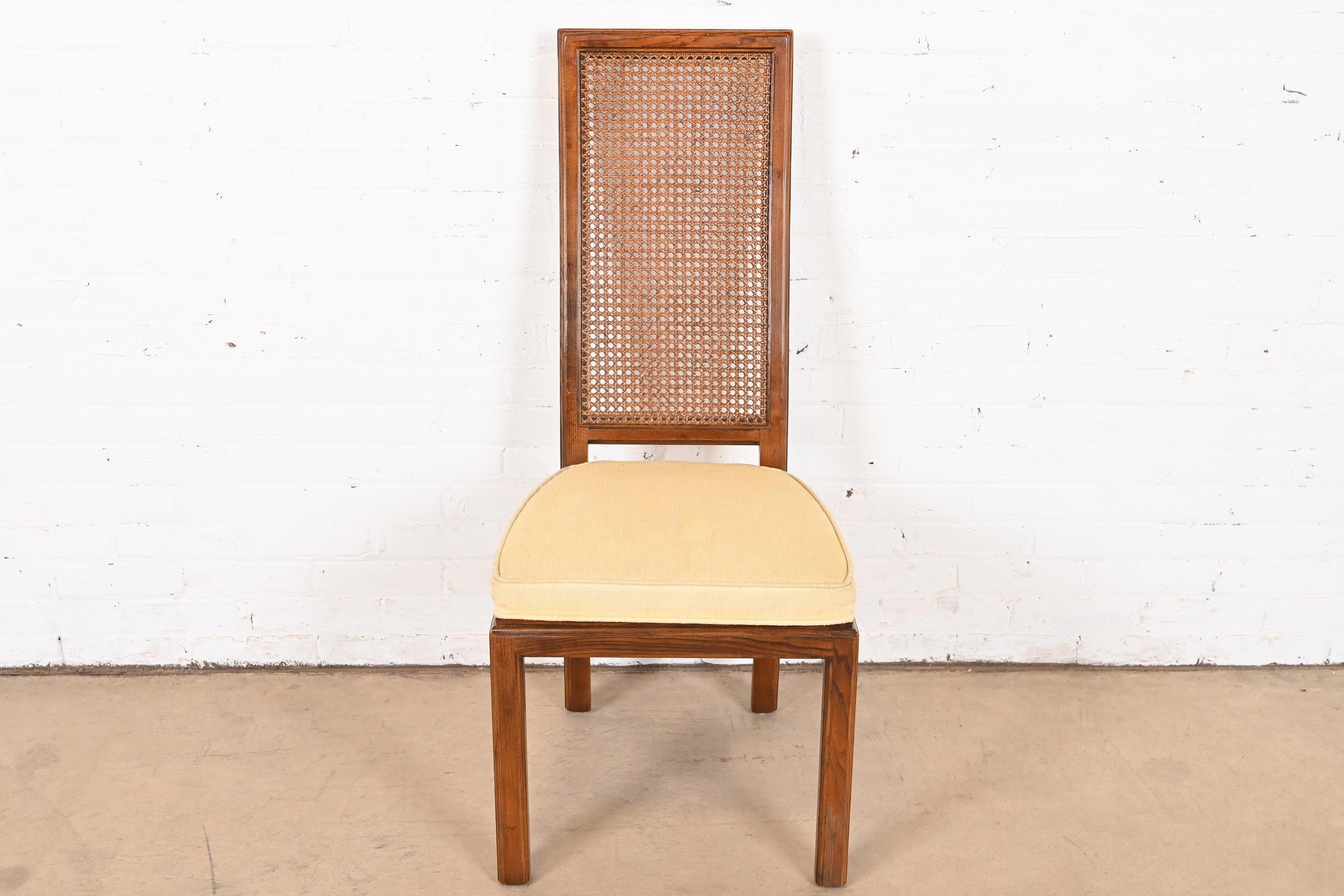 A beautiful Mid-Century Modern high back dining chair or side chair

By Henredon

USA, Circa 1970s

Oak frame, with cane back and upholstered seat.

Dimensions: 18.75