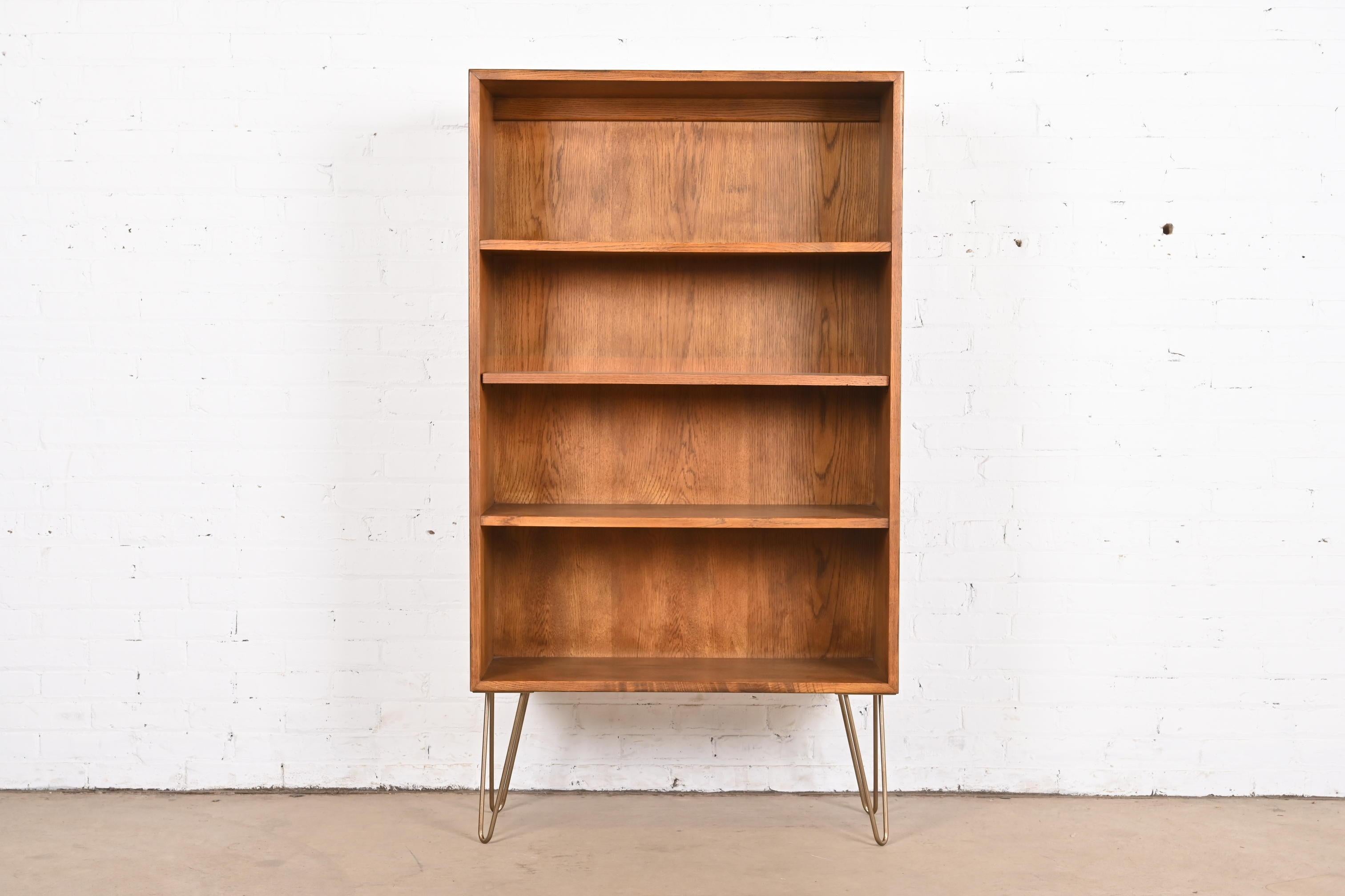 A beautiful Mid-Century Modern oak bookcase

By Henredon

USA, Circa 1970s

Oak case, with brass finished steel hairpin legs.

Measures: 33
