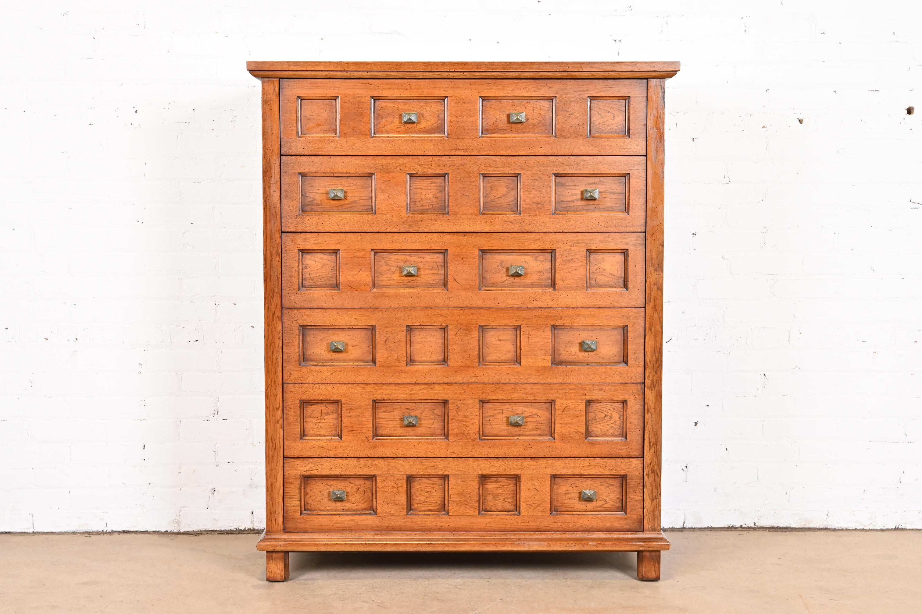 A gorgeous mid-century modern Spanish Colonial style highboy dresser

By Henredon

USA, 1960s

Carved walnut, with original brass hardware.

Measures: 42