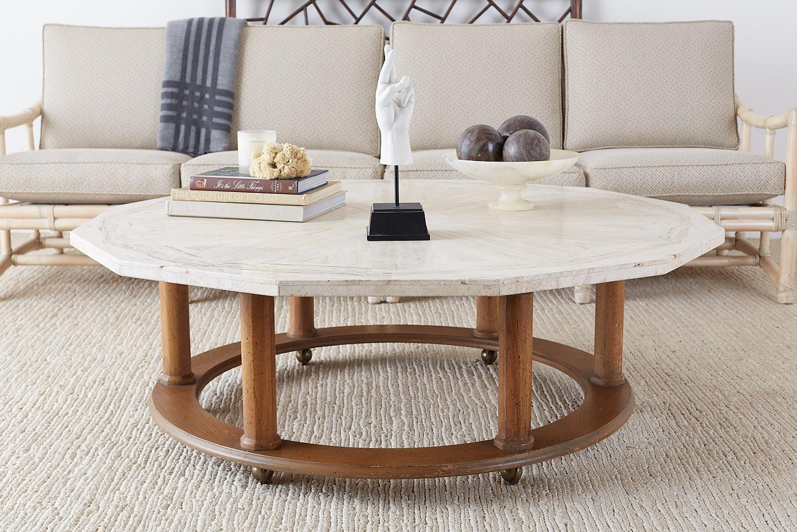 Stylish Mid-Century Modern coffee or cocktail table featuring a travertine top made by Henredon. The stone top has a decagon shape with a faceted edge and a geometric starburst design in the stone. Supported by an octagonal base with neoclassical