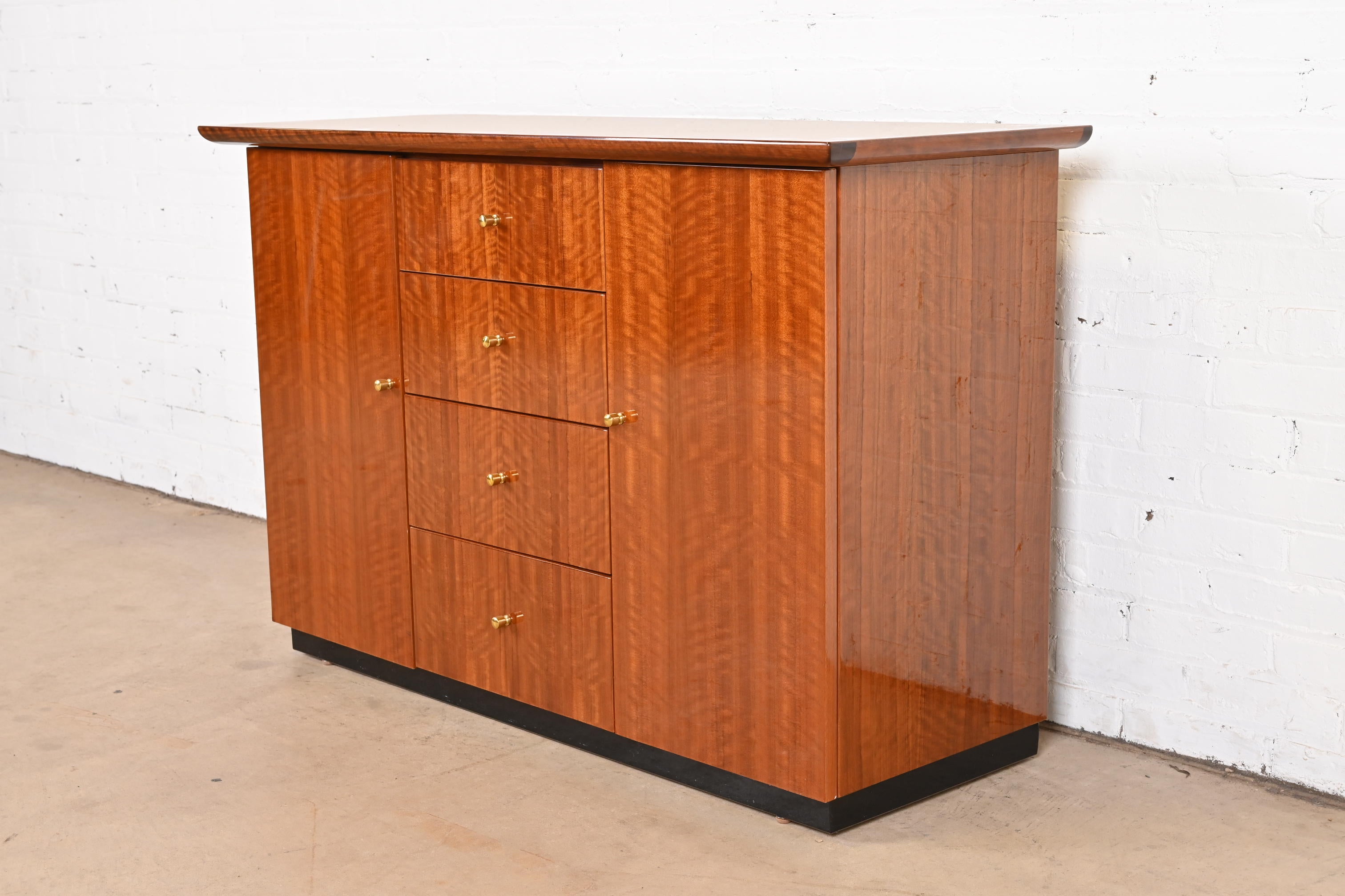 A beautiful modern French Empire style sideboard server or bar cabinet

By Henredon

USA, Late 20th century

Gorgeous exotic Brazilian Daniella wood, with original brass hardware.

Measures: 49.5