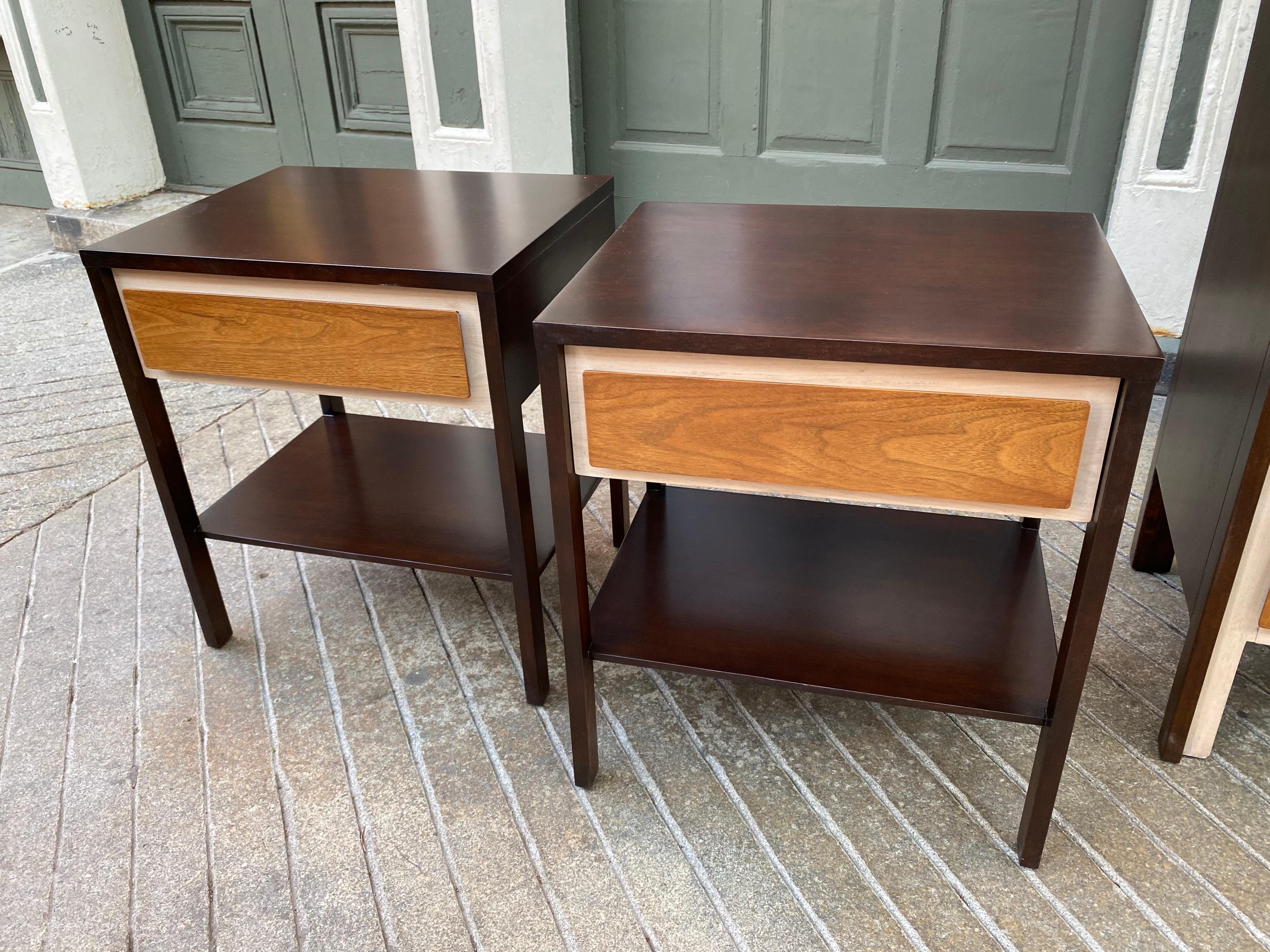 Henredon nightstands inspired by Gio Ponti's 1958 Design for The Singer Furniture Company. Outer body finished in a dark walnut, drawer fronts in a light walnut with a cream back. All refinished and ready to go!
