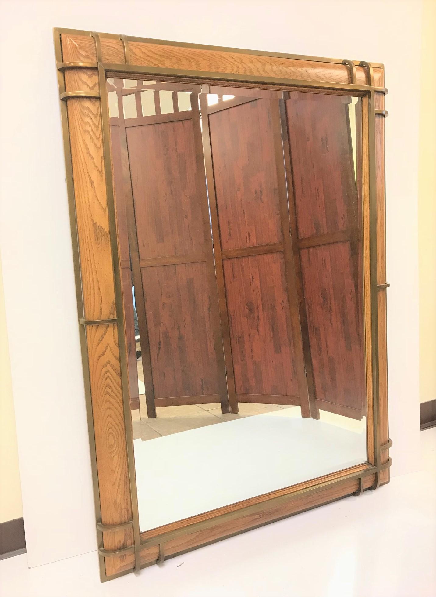 Henredon oak and bronze trim mirror. Has a beveled mirror.