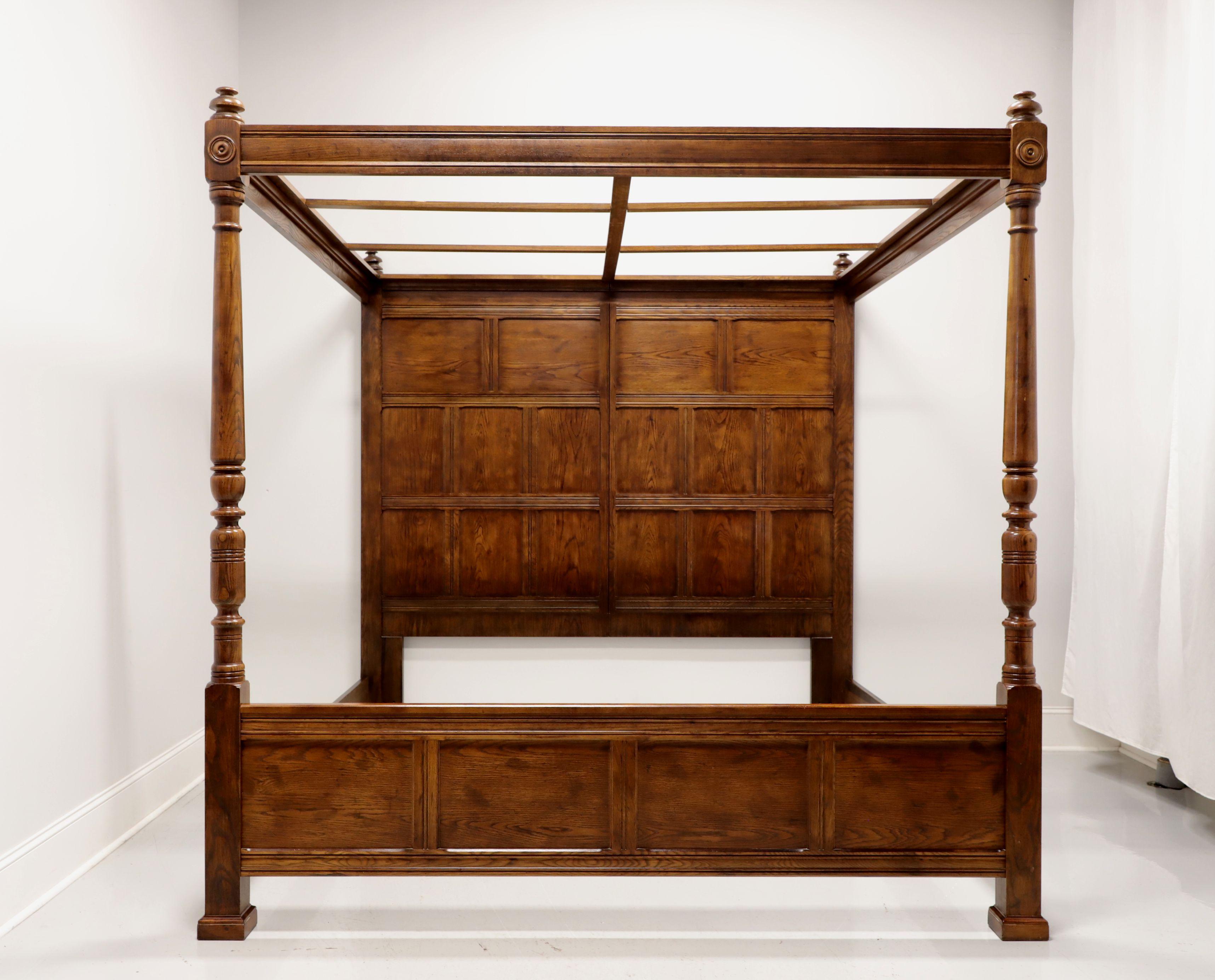 An English Tudor style king size four poster paneled bed with canopy by Henredon. Solid oak with paneled headboard, four turned posts capped by finials and a canopy. No mattress supports provided. Made in the USA, circa 1980's.

Measures: 83.5 W,