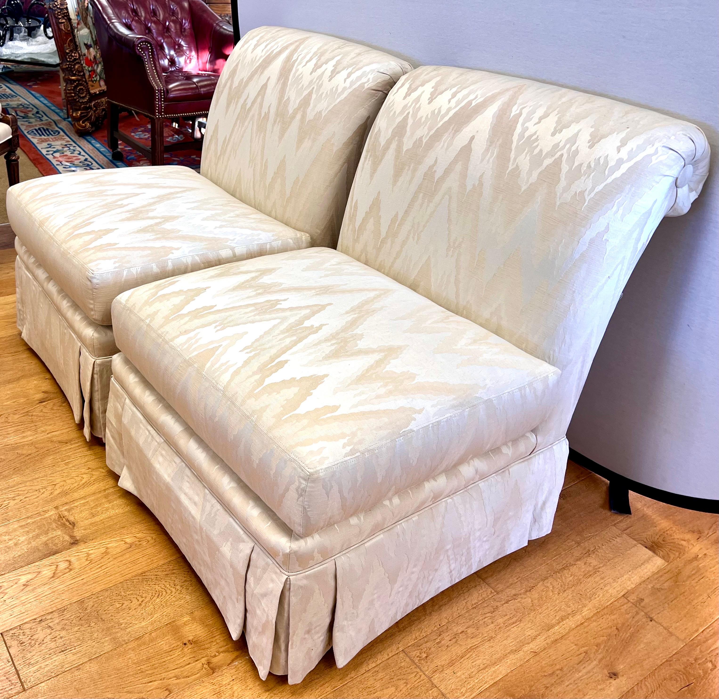 Elegant pair of Henredon signed slipper chairs that have custom upholstery in a silk chevron pattern will rolled back arm and skirt.  They are gorgeous with great scale and better lines.  We understand that shipping prices have risen but please