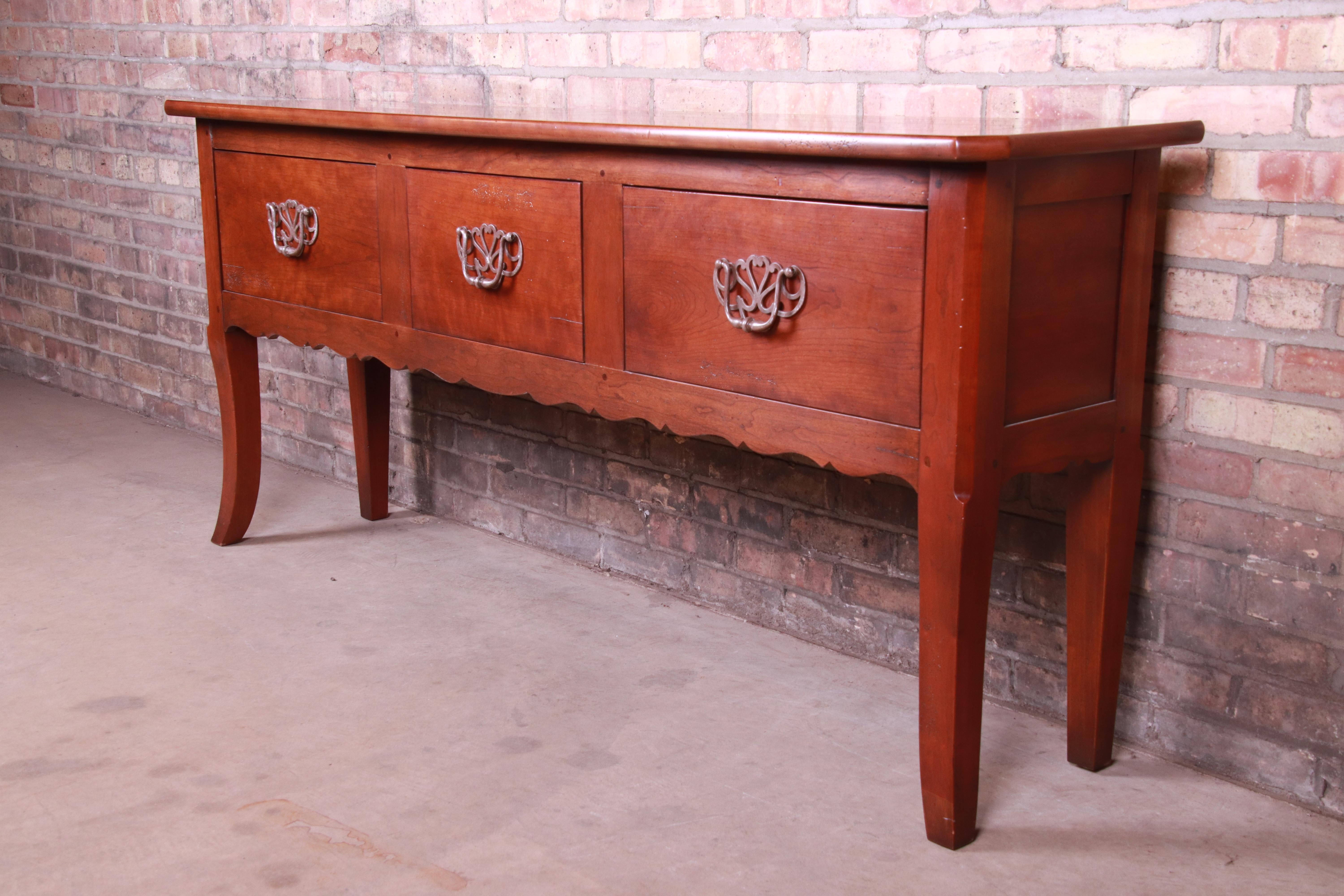 An exceptional French Provincial solid cherrywood sideboard server or console table

By Henredon 