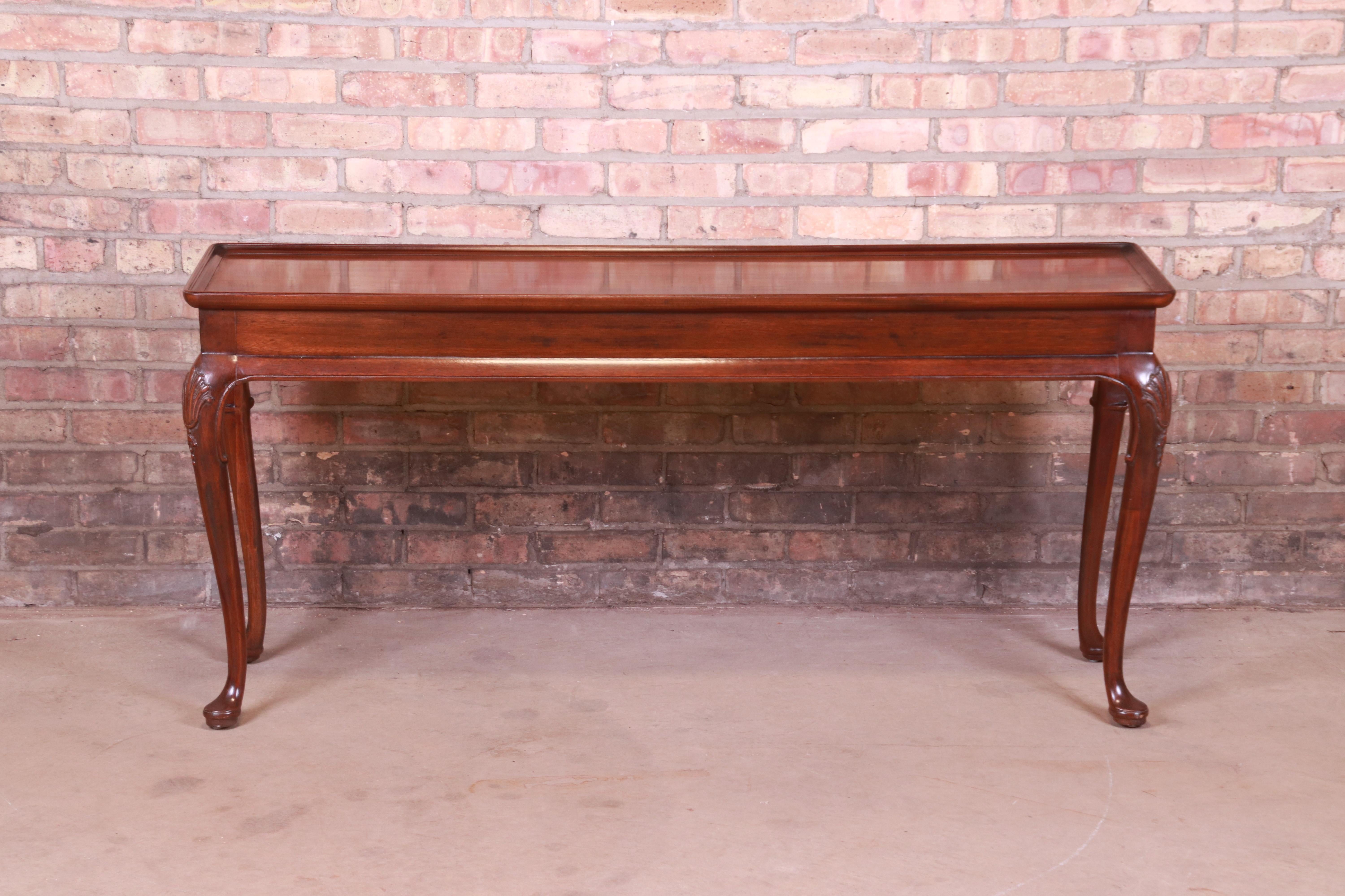 A gorgeous Queen Anne style carved mahogany console or sofa table

By Henredon 