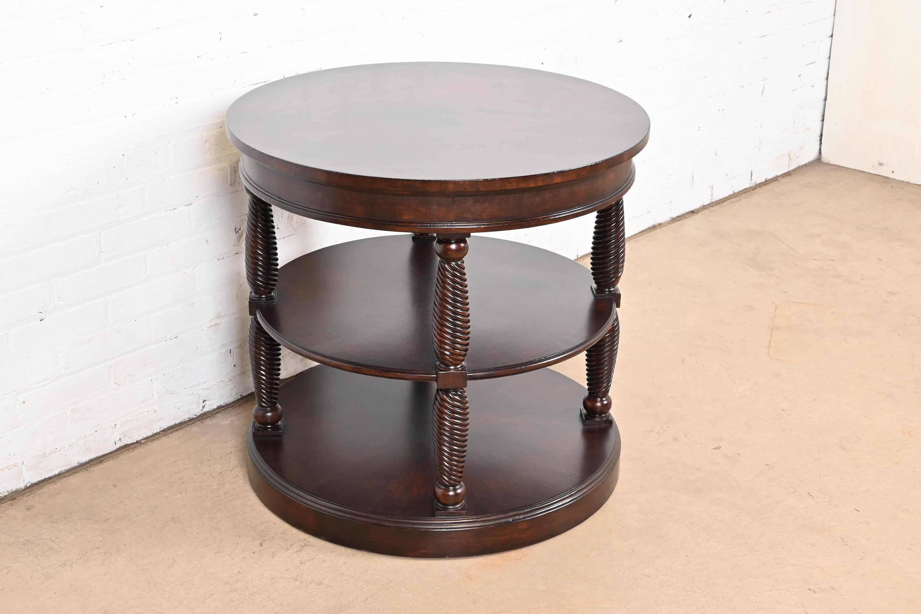 A gorgeous Regency or Empire style banded mahogany three-tier drum side table

By Henredon

Colombia, Circa Late 20th Century

Measures: 30.13