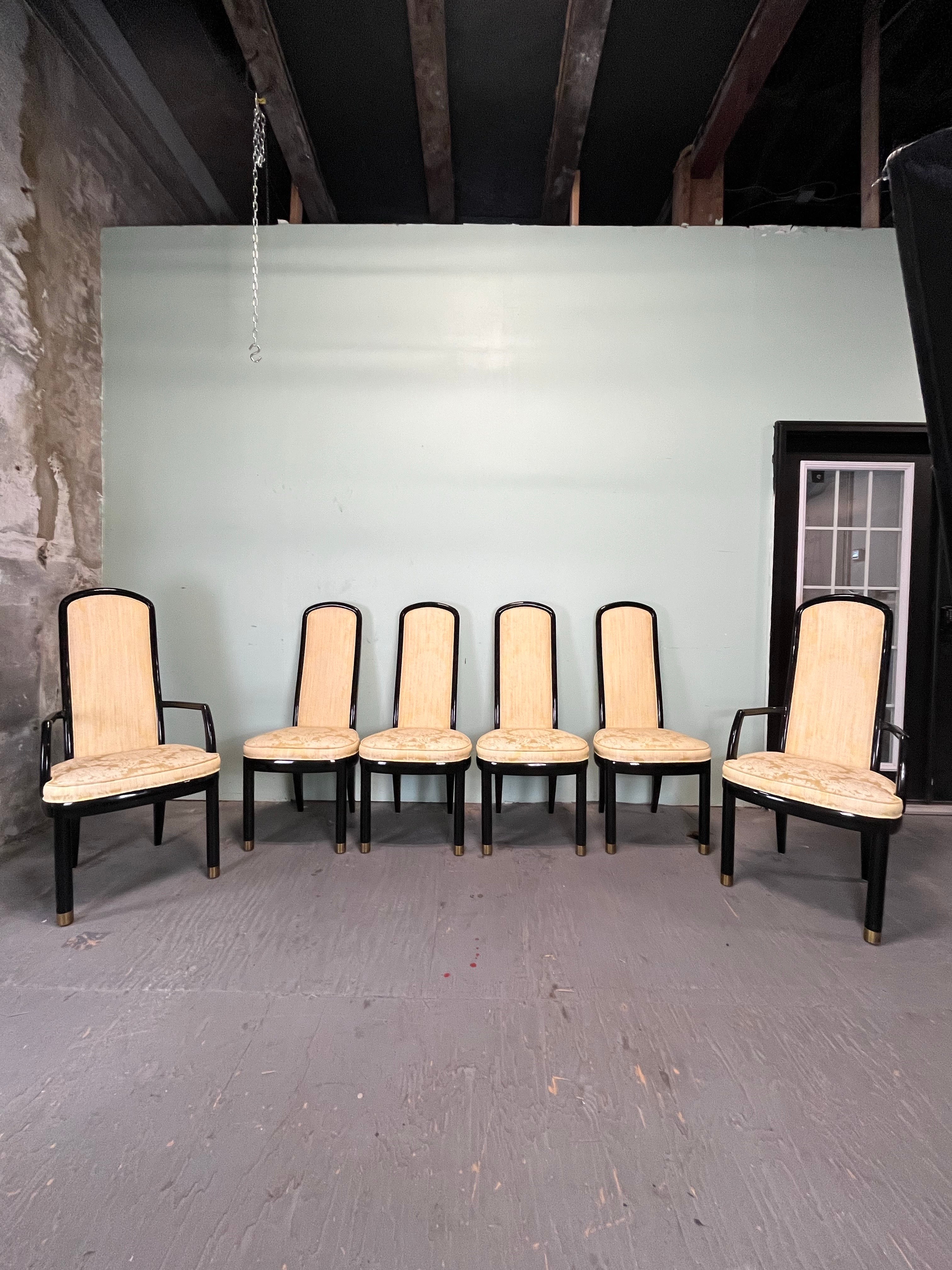 Henredon dining chairs, comprising a pair of arm chairs and six side chairs, each black lacquer form terminating in brass end caps, bearing Henredon labels. Arm 44 1/2