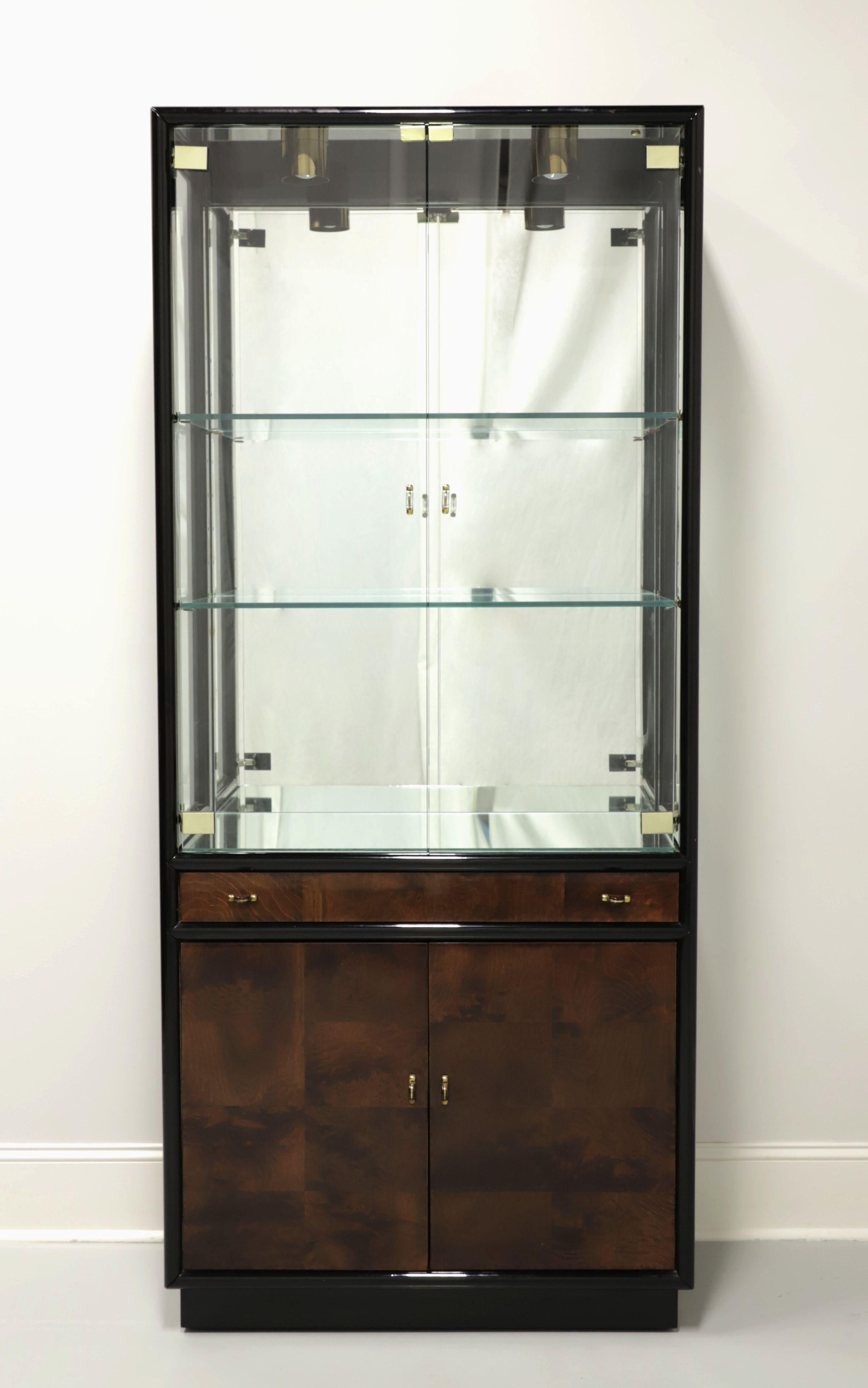 An Asian influenced china display cabinet by Henredon, from their Scene Three Collection. Black lacquered hardwood, burlwood door & drawer fronts, brass hardware and brass with burlwood inserts door & drawer pulls. Upper portion is lighted with dual