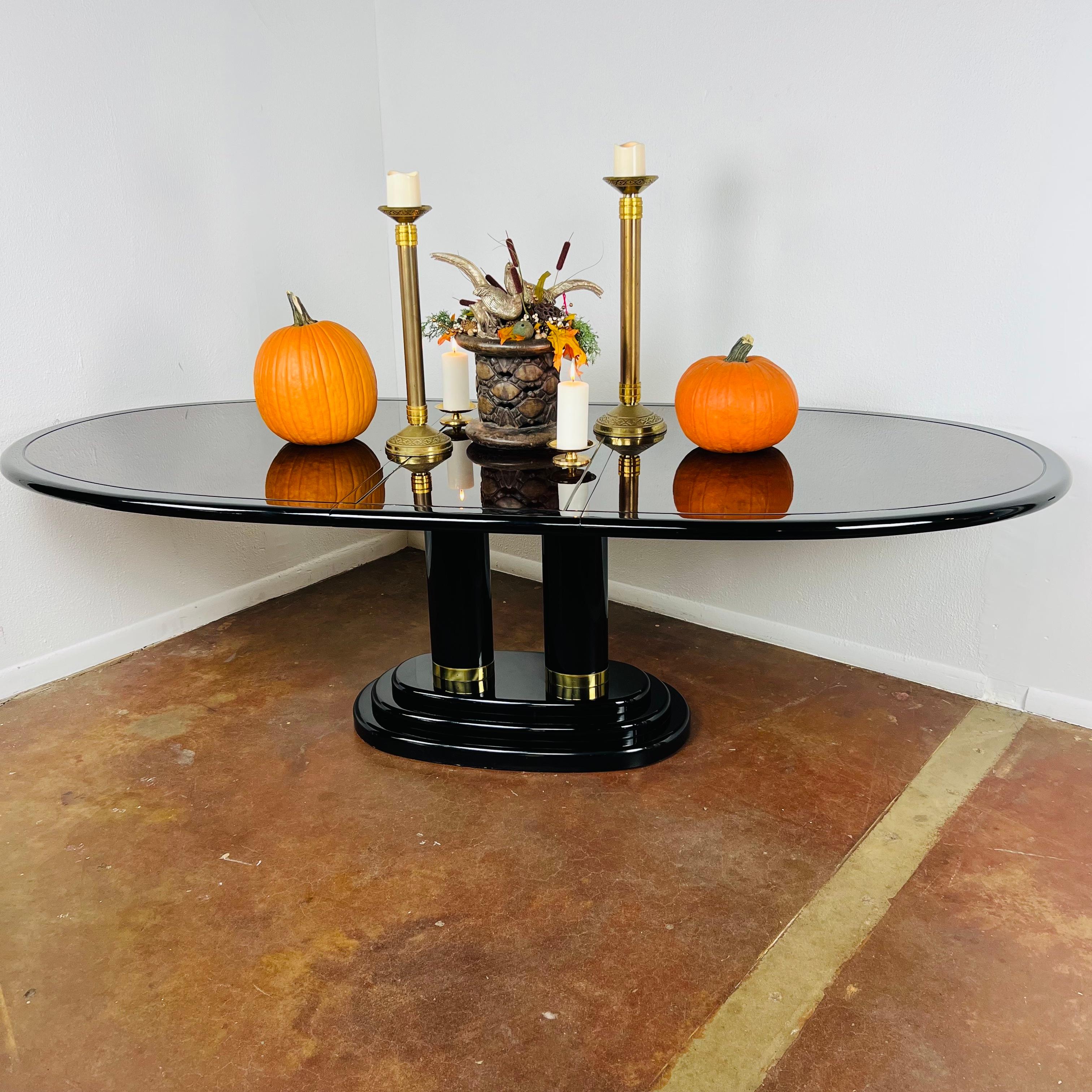 Vintage henredon scene three dining table featuring sleek lacquered table top with pedestal base and brass accents. Goes beautifully with the matching cane seat chairs, available in separate listing. Includes 20