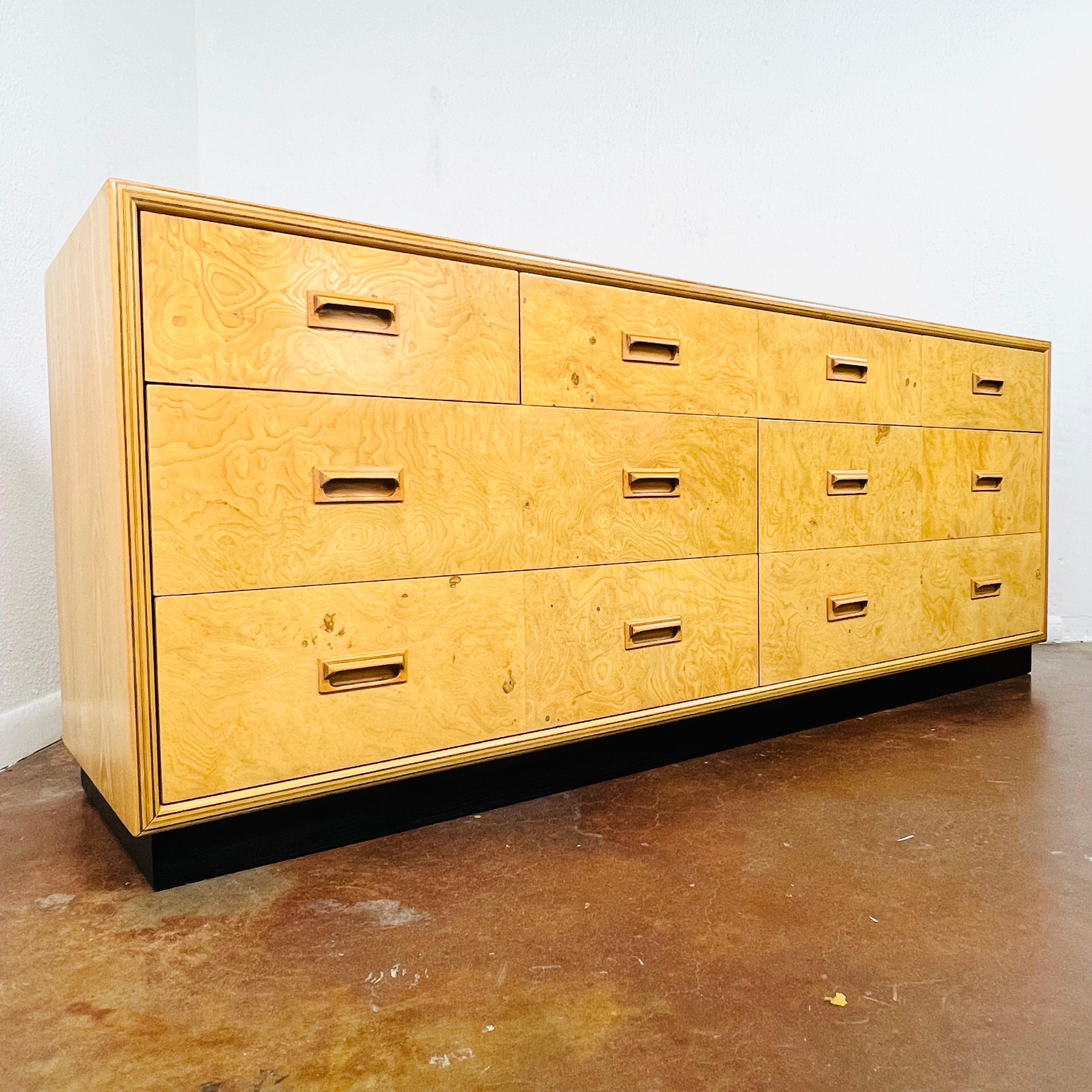 Vintage seven-drawer chest of drawers from the Henredon Scene Two Collection. This unique burl wood dresser features a great modernist form, dovetailed drawer construction, inlaid sculpted wood pulls, ebonized plinth, and great overall form. The