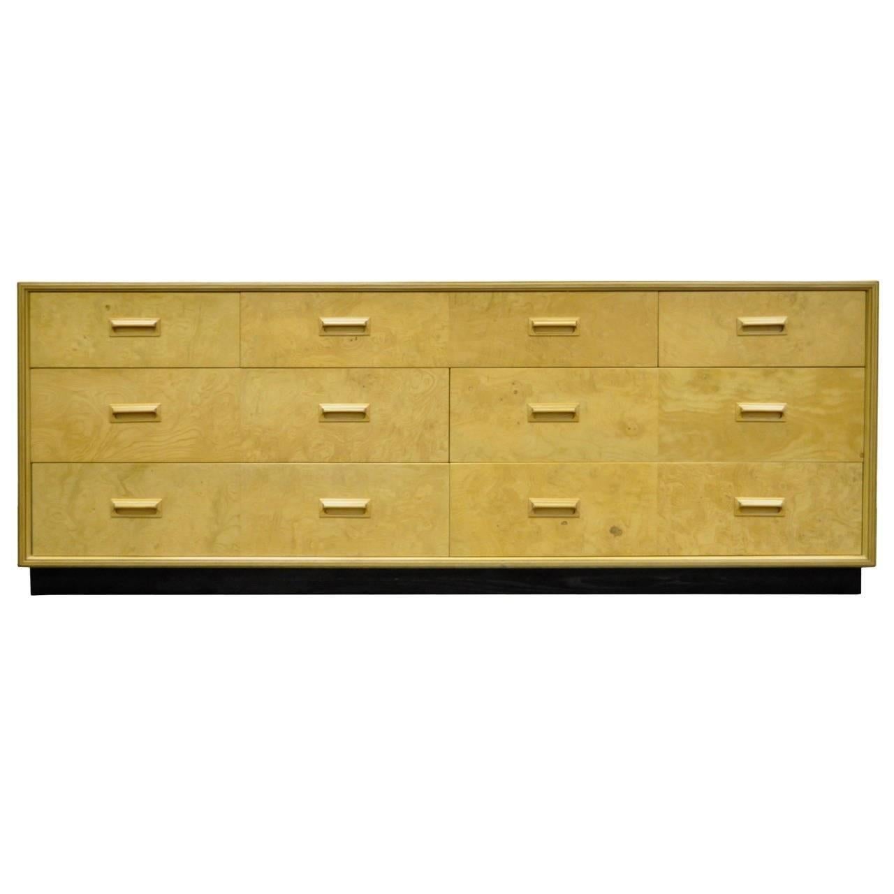 Vintage seven-drawer chest of drawers from the Henredon scene two collection. This unique burl wood dresser features a great modernist form, dovetailed drawer construction, inlaid sculpted wood pulls, ebonized plinth, and great overall form.